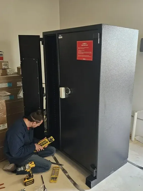 A Provo locksmith repairing a safe for a business.