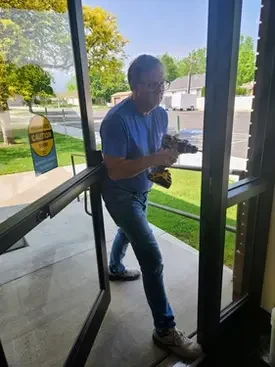 Payson Lock & Key technician installing electronic access control on a church building in Utah.