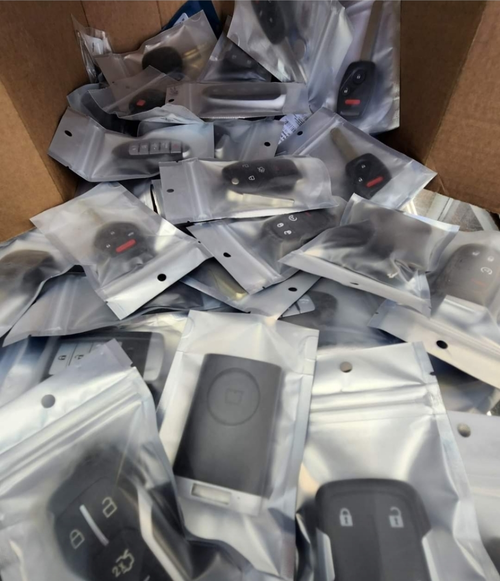 Transponder car keys spilling out of a box.
