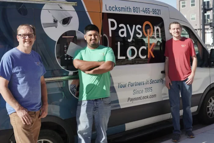 Three Payson Lock & Key locksmiths standing by mobile vehicle in Payson, Utah.
