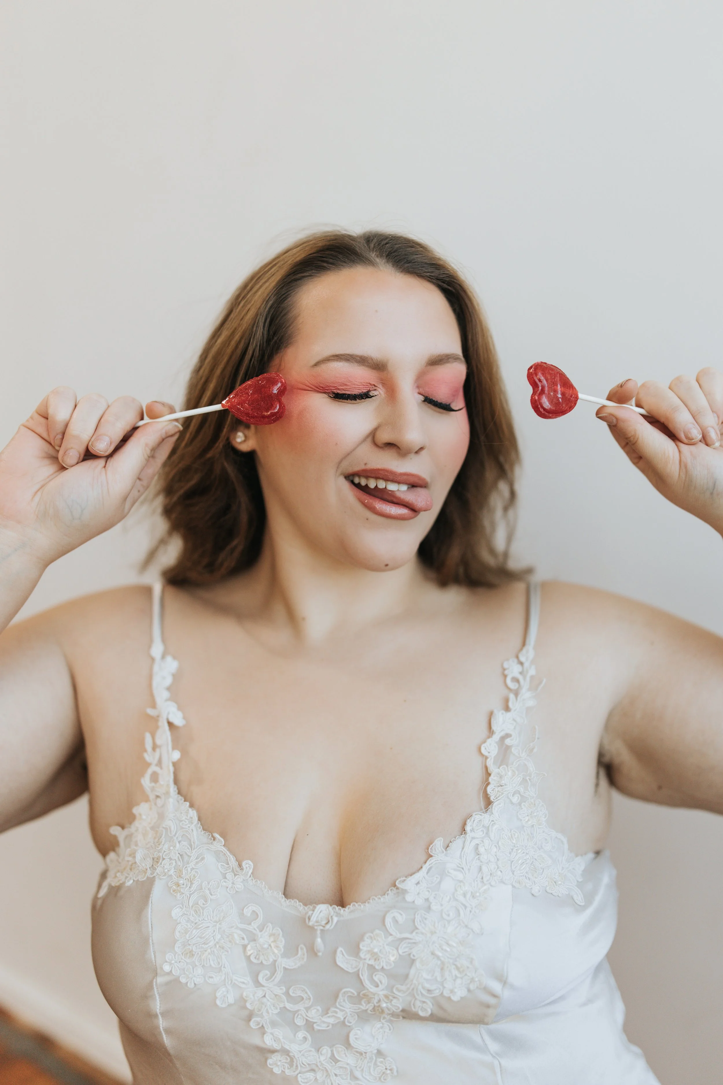  Model poses with lollipops for a creative Valentine’s Day photoshoot. 