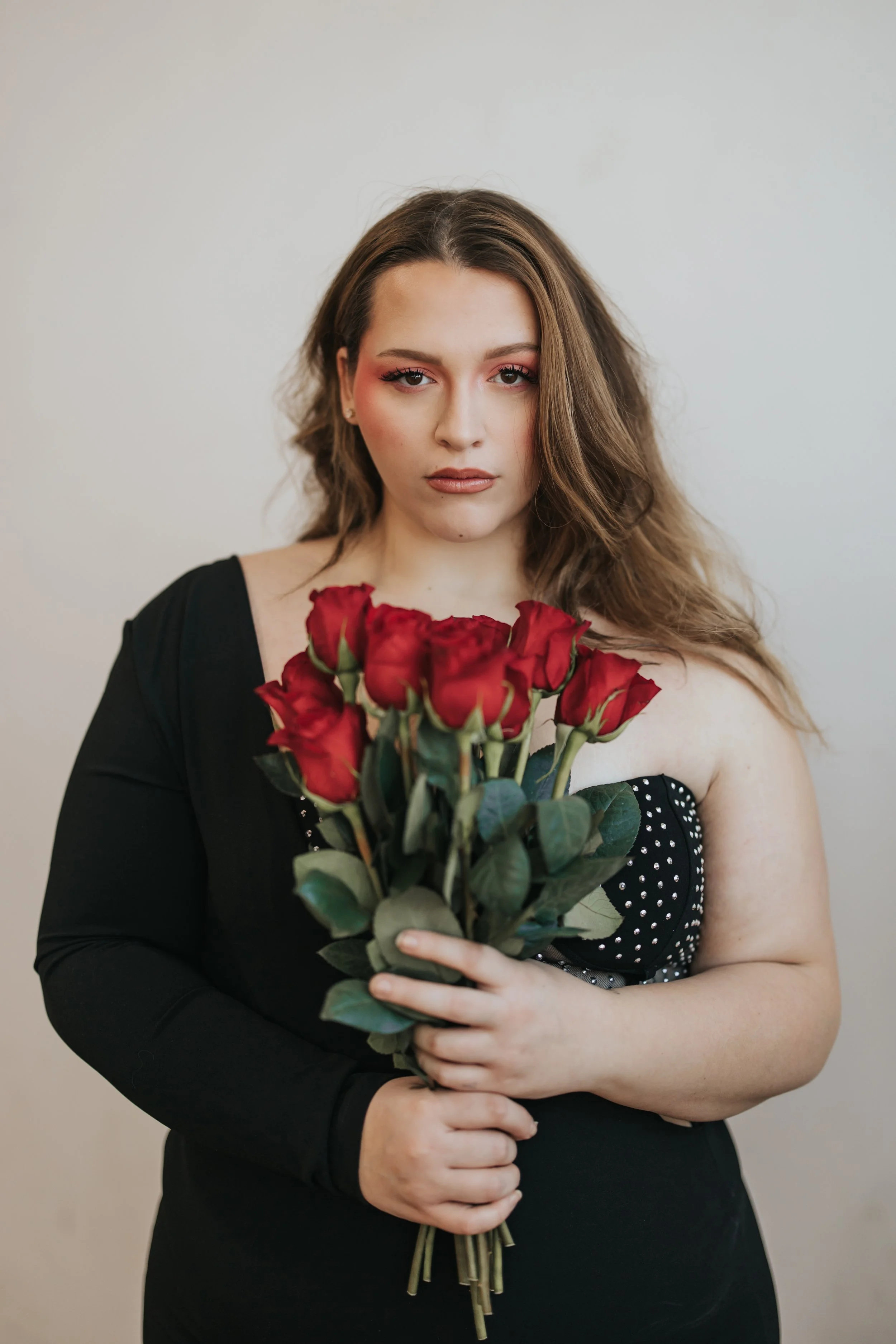  Model poses with red roses for a creative Valentine’s Day photoshoot. 