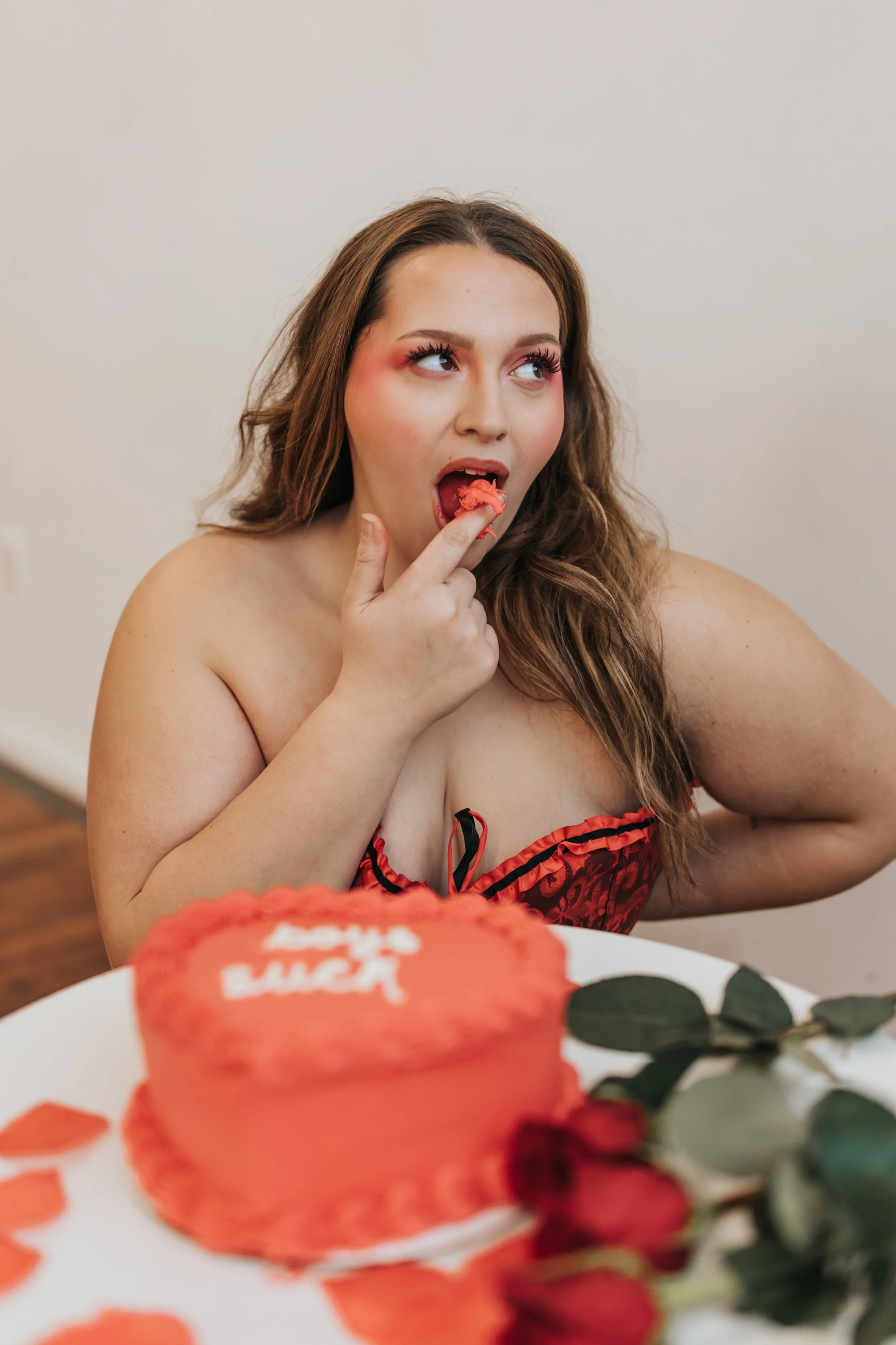  Model poses while eating cake for a creative anti-Valentine’s Day fashion photoshoot. 