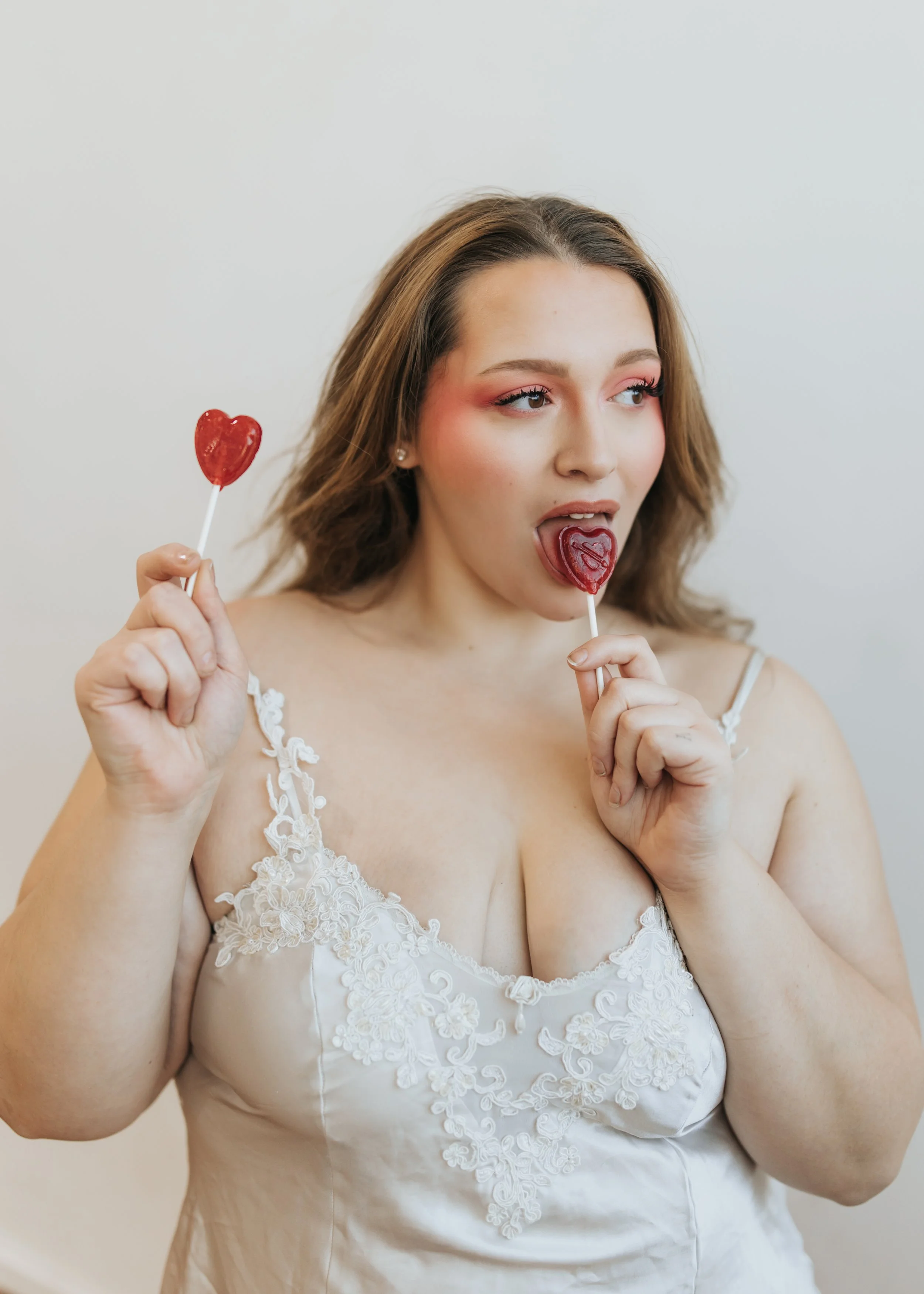 Model poses with lollipops for a creative Valentine’s Day fashion photoshoot. 