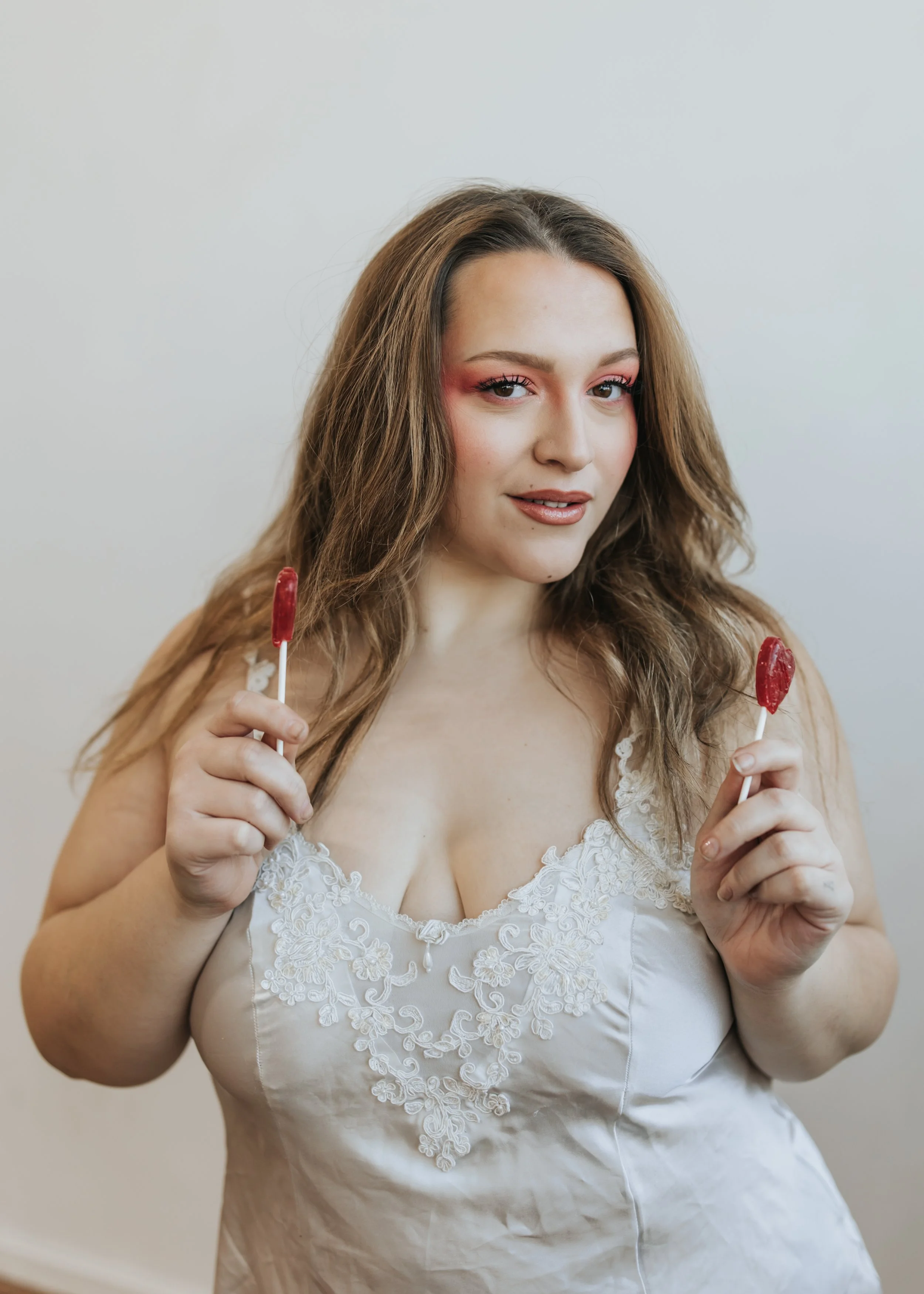  Model poses with lollipops for a creative Valentine’s Day fashion photoshoot. 