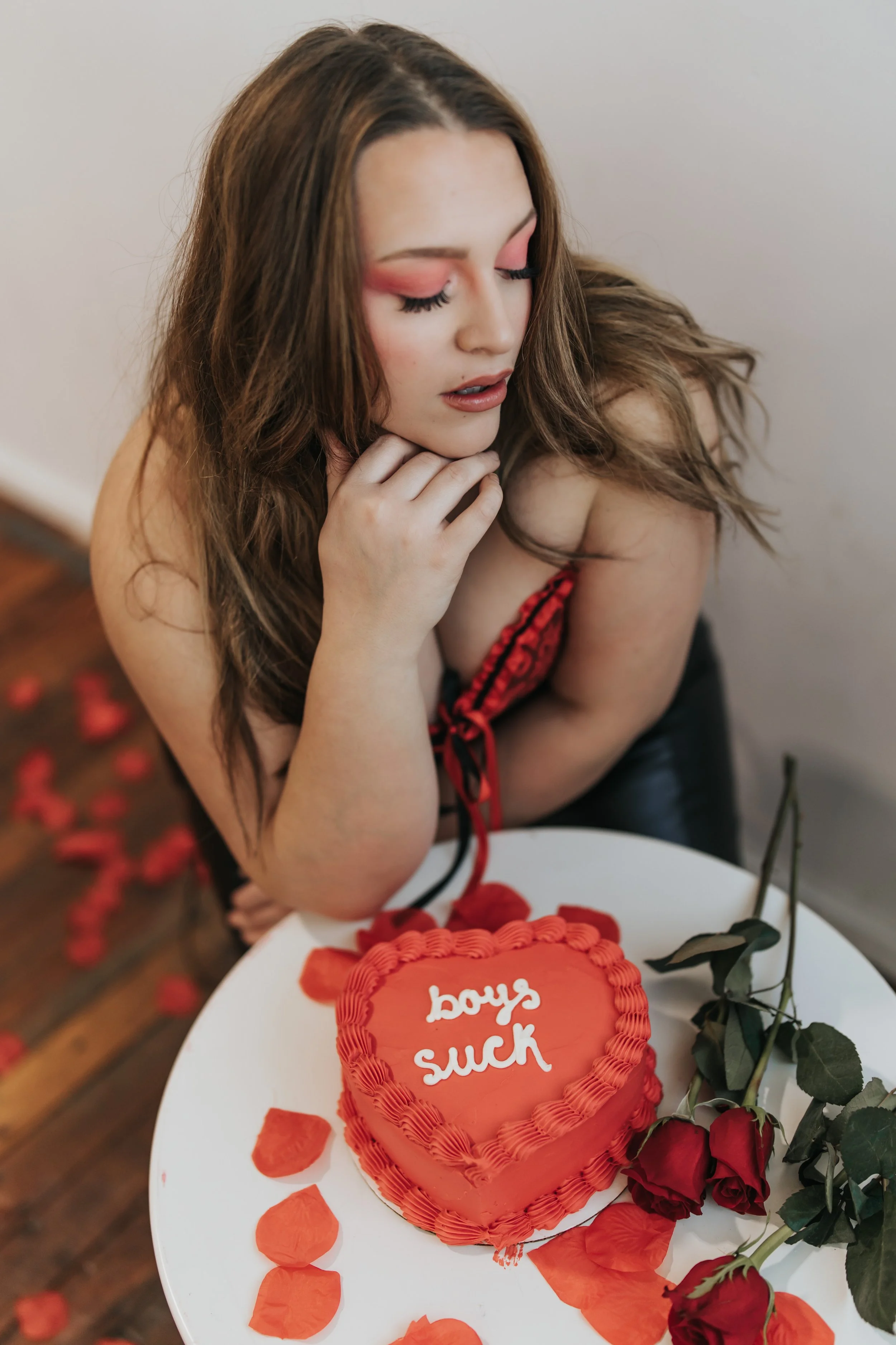  Fashion model poses with a heart-shaped cake for a creative Valentine’s Day photoshoot. 