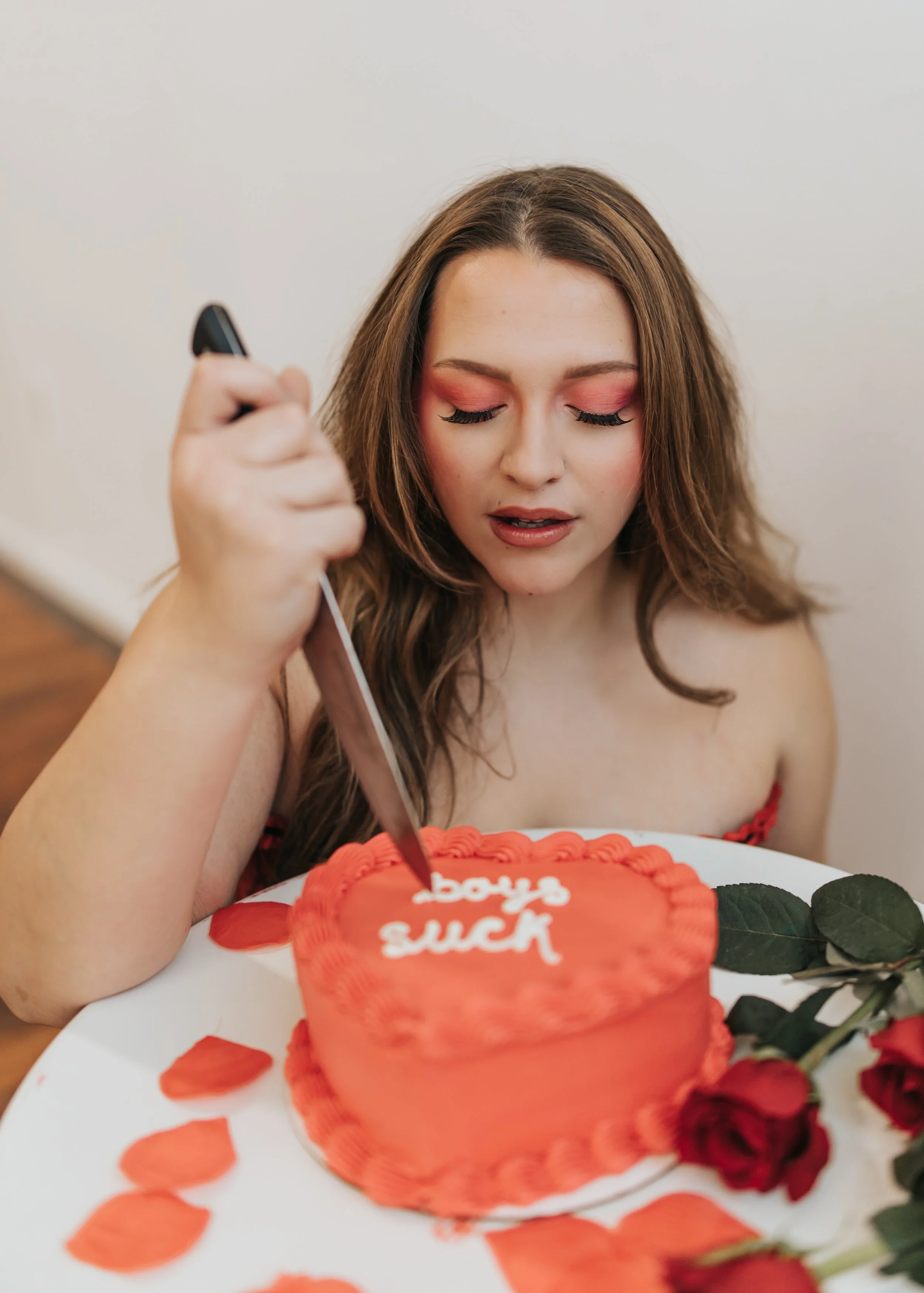  Fashion model poses with a heart-shaped cake for a creative Valentine’s Day photoshoot. 