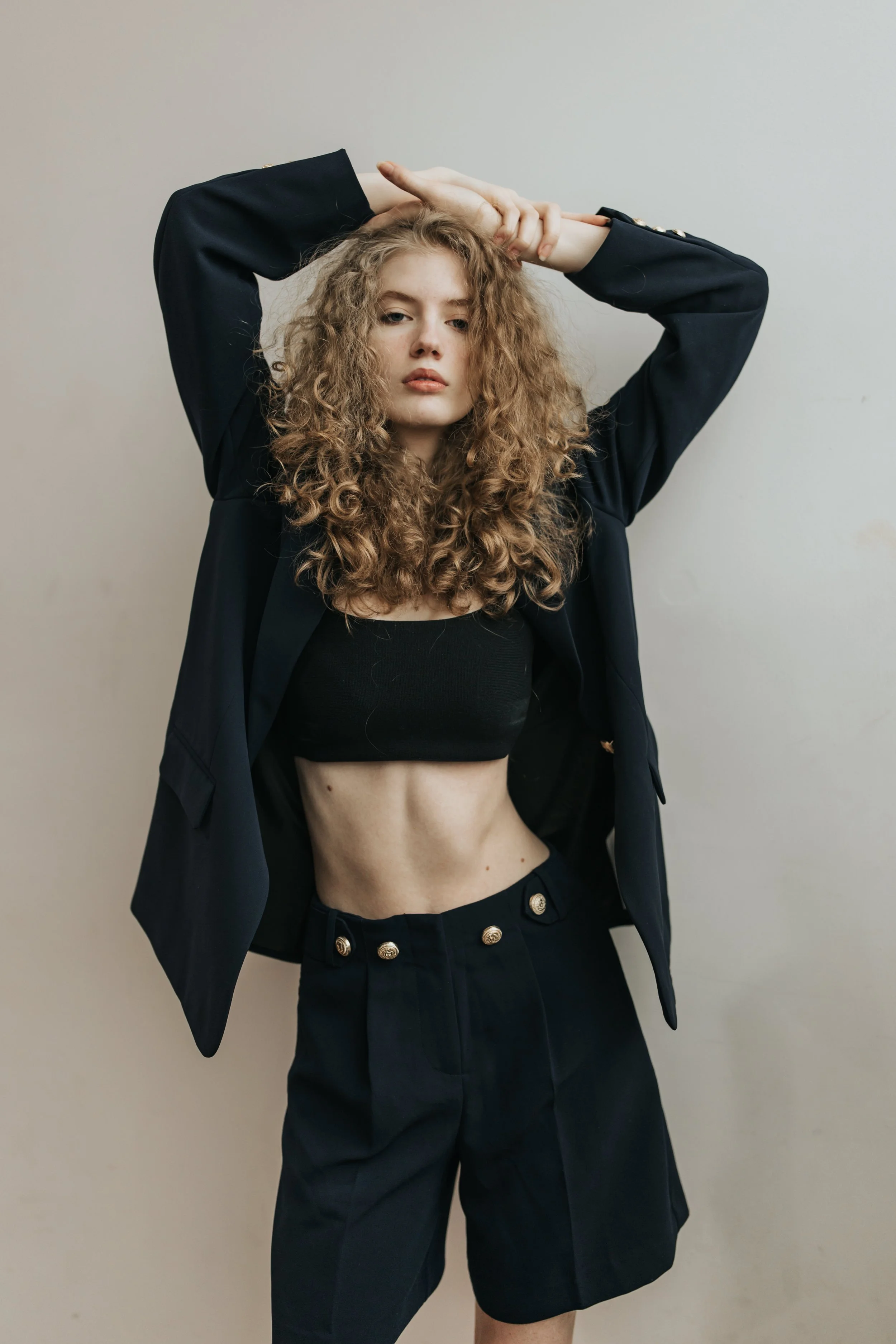  Blonde model poses for a fashion test shoot wearing a two piece outfit. 