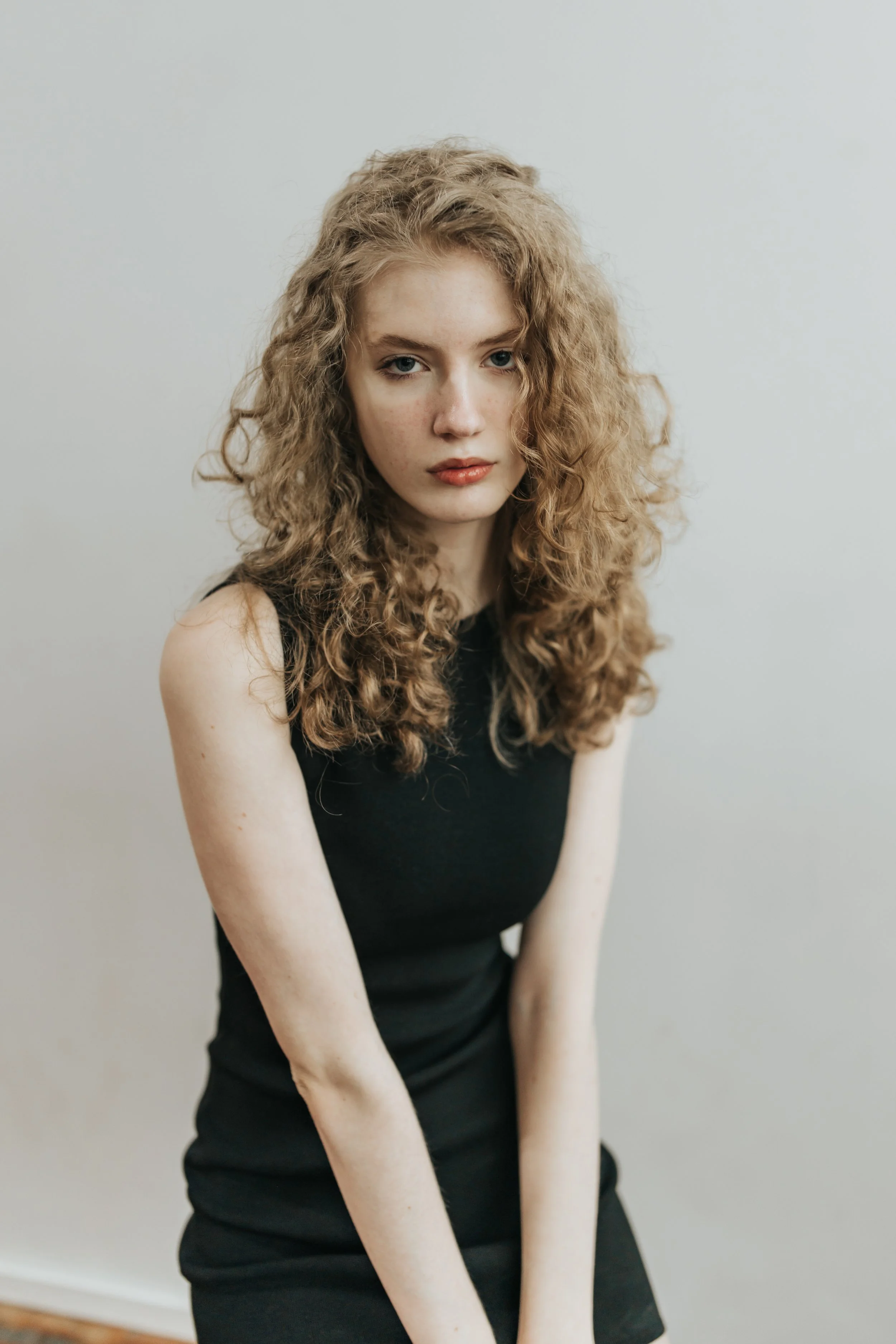  Blonde model poses for a fashion test shoot wearing a black outfit. 