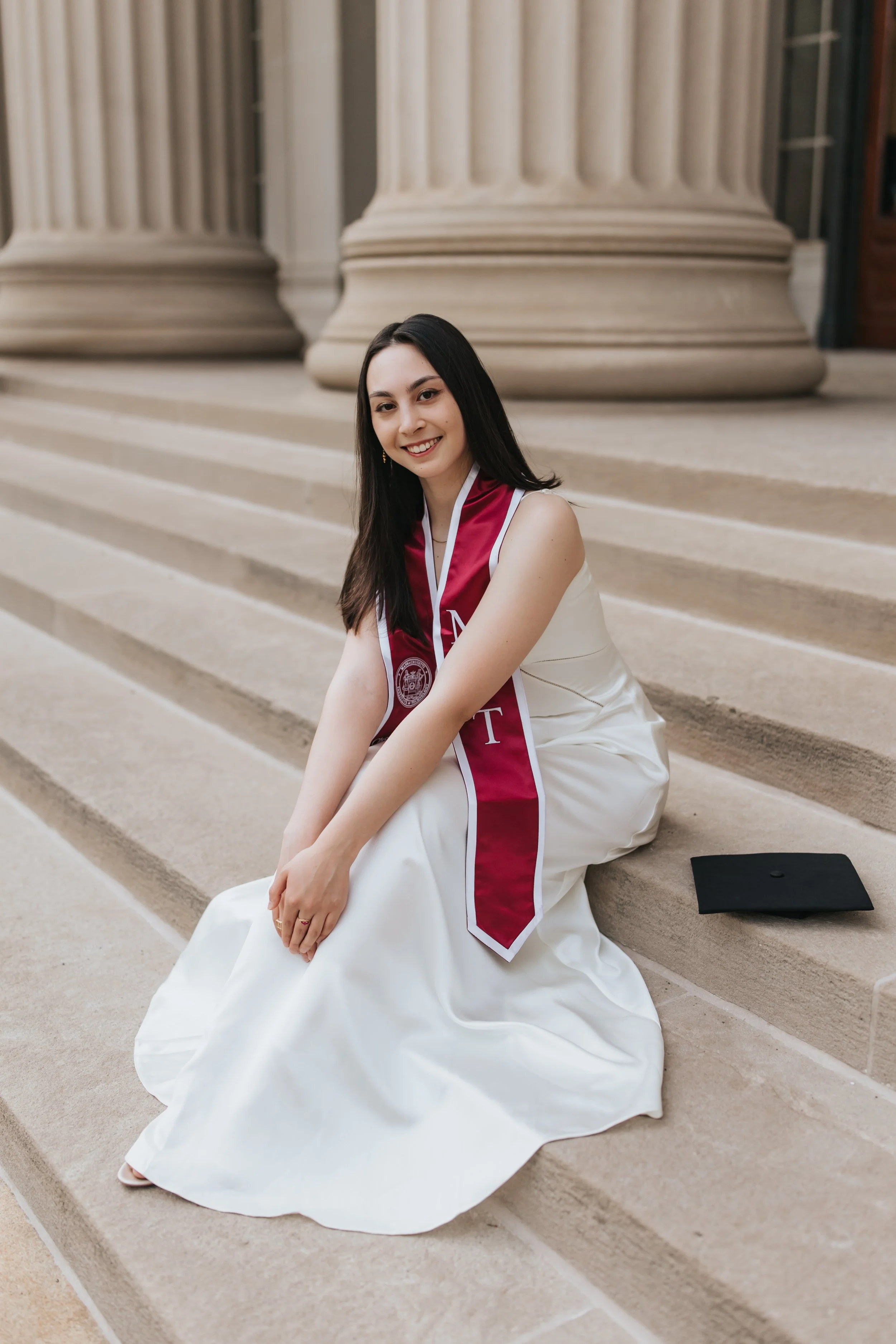  Claire, an MIT graduate, poses for her Boston graduation photos in a long white dress on the MIT campus 
