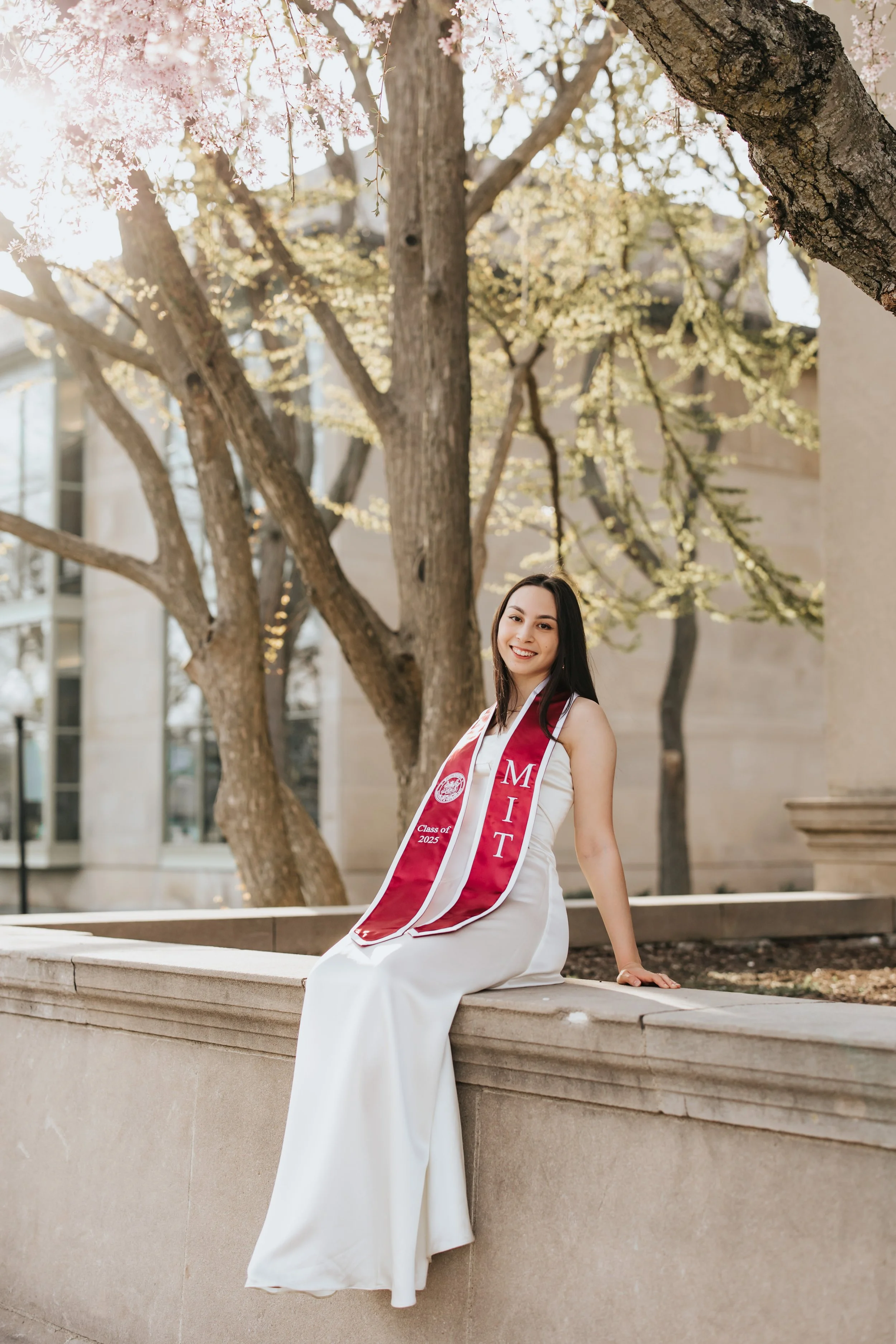  Claire, an MIT graduate, poses for her Boston graduation photos in a long white dress on Memorial Drive 