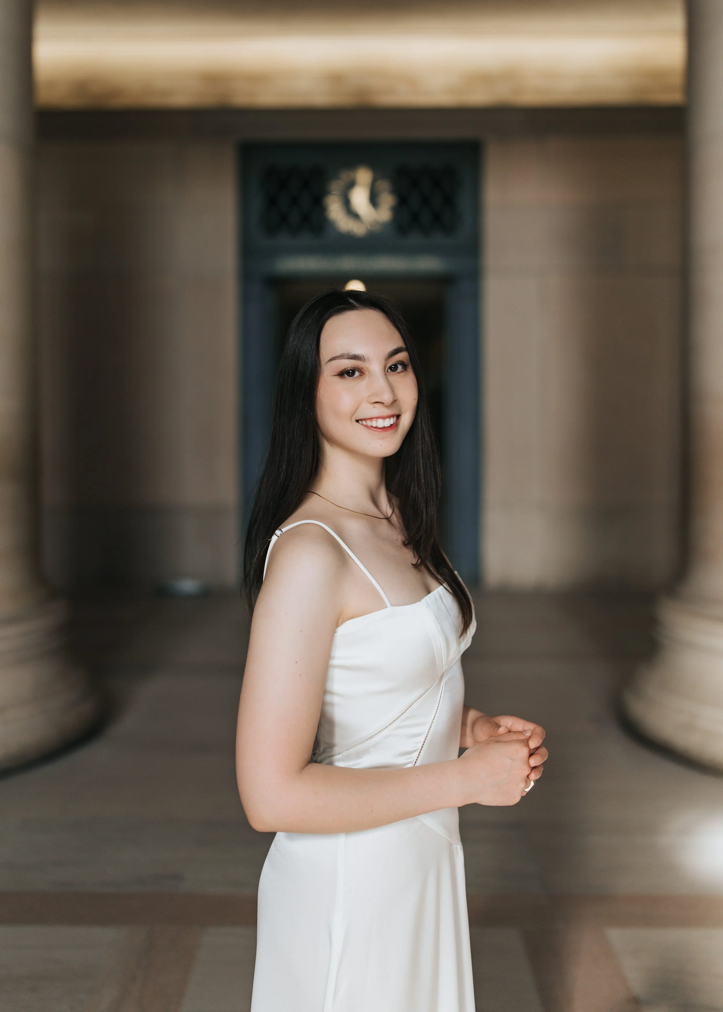 Claire, an MIT graduate, poses for her Boston graduation photos in a long white dress on the MIT campus 