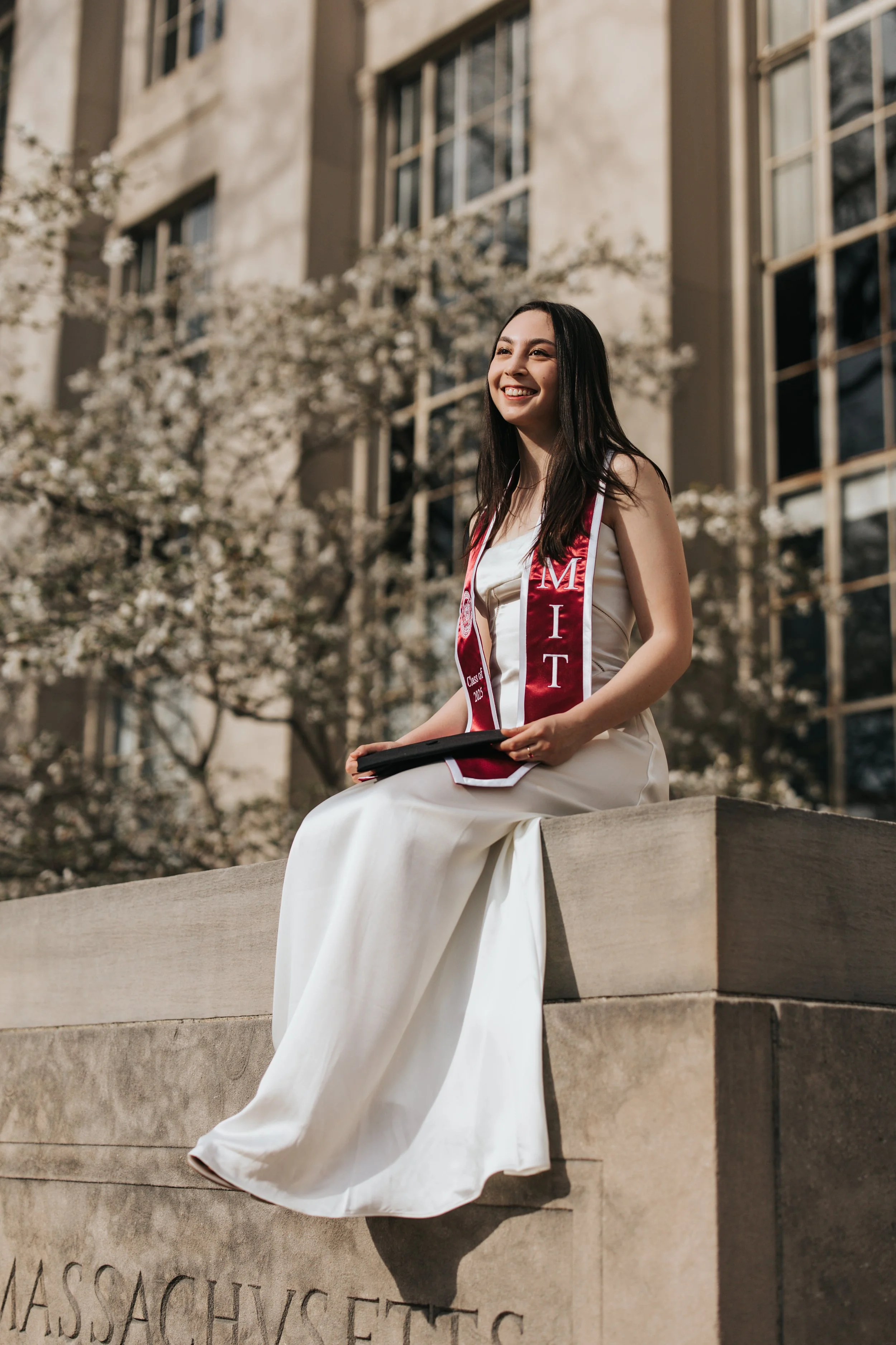  Claire, an MIT graduate, poses for her Boston graduation photos in a long white dress on the MIT campus 