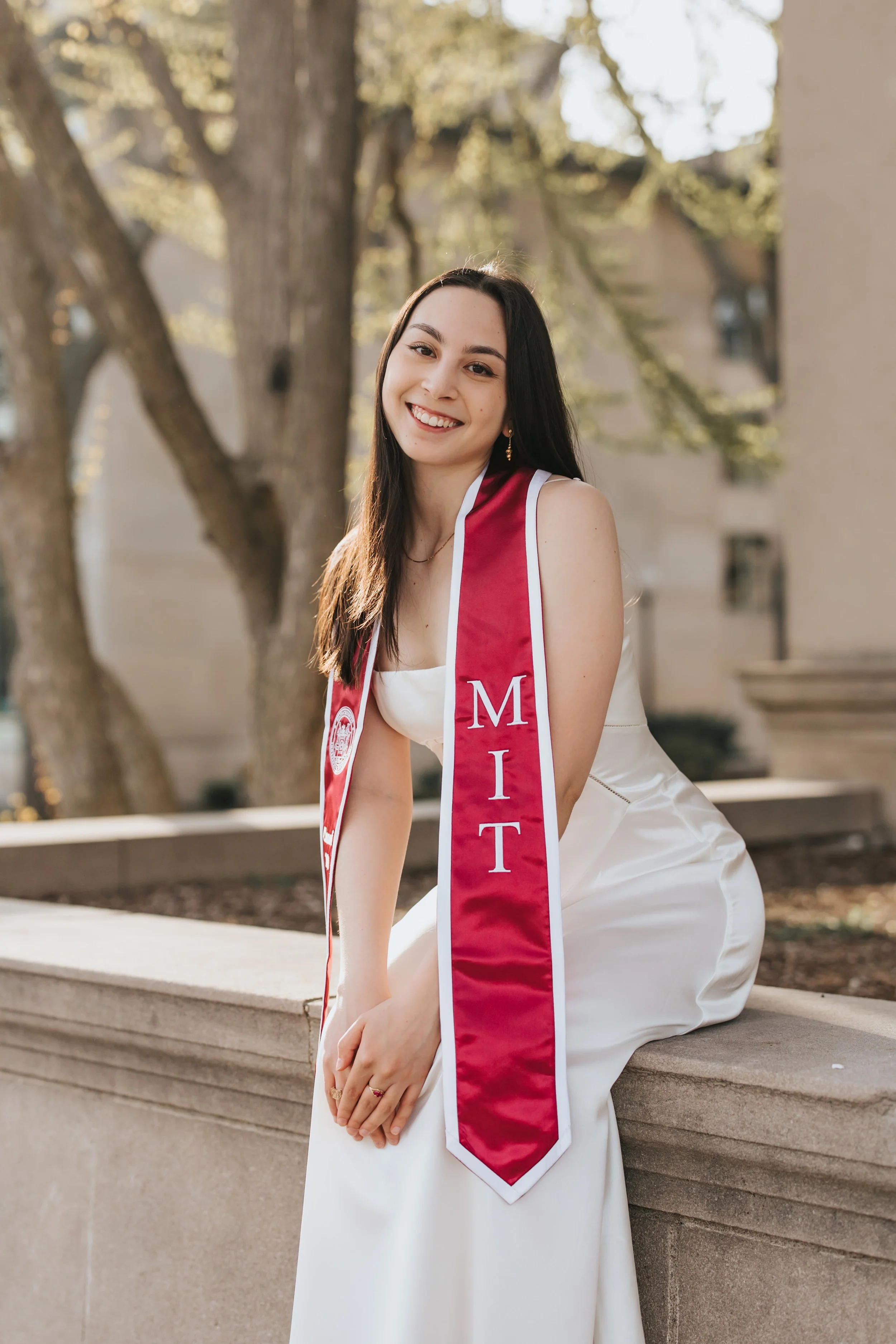  Claire, an MIT graduate, poses for her Boston graduation photos in a long white dress at the Main Entrance of the MIT campus 