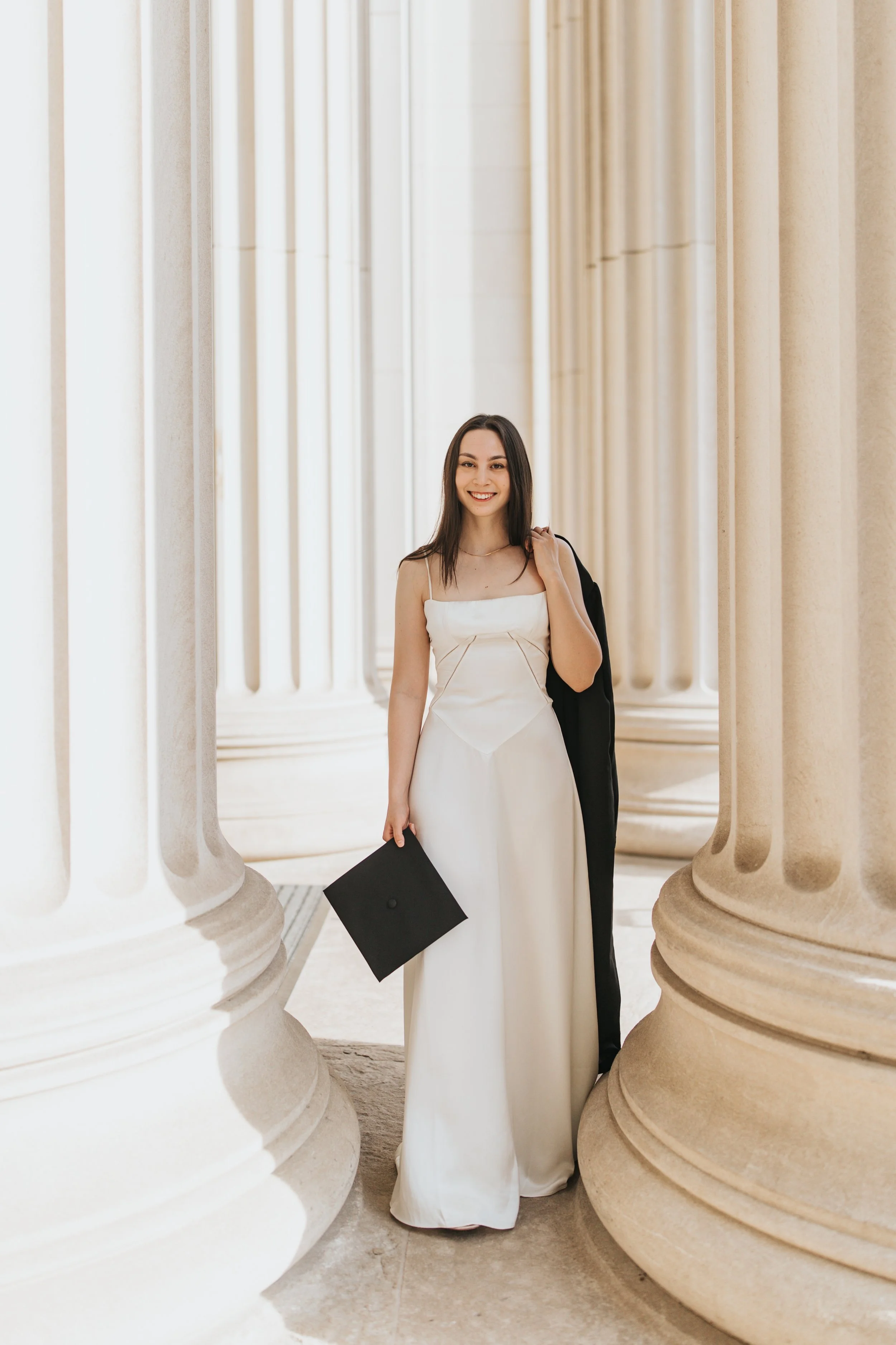  Claire, an MIT graduate, poses for her Boston graduation photos in a long white dress on the MIT campus 