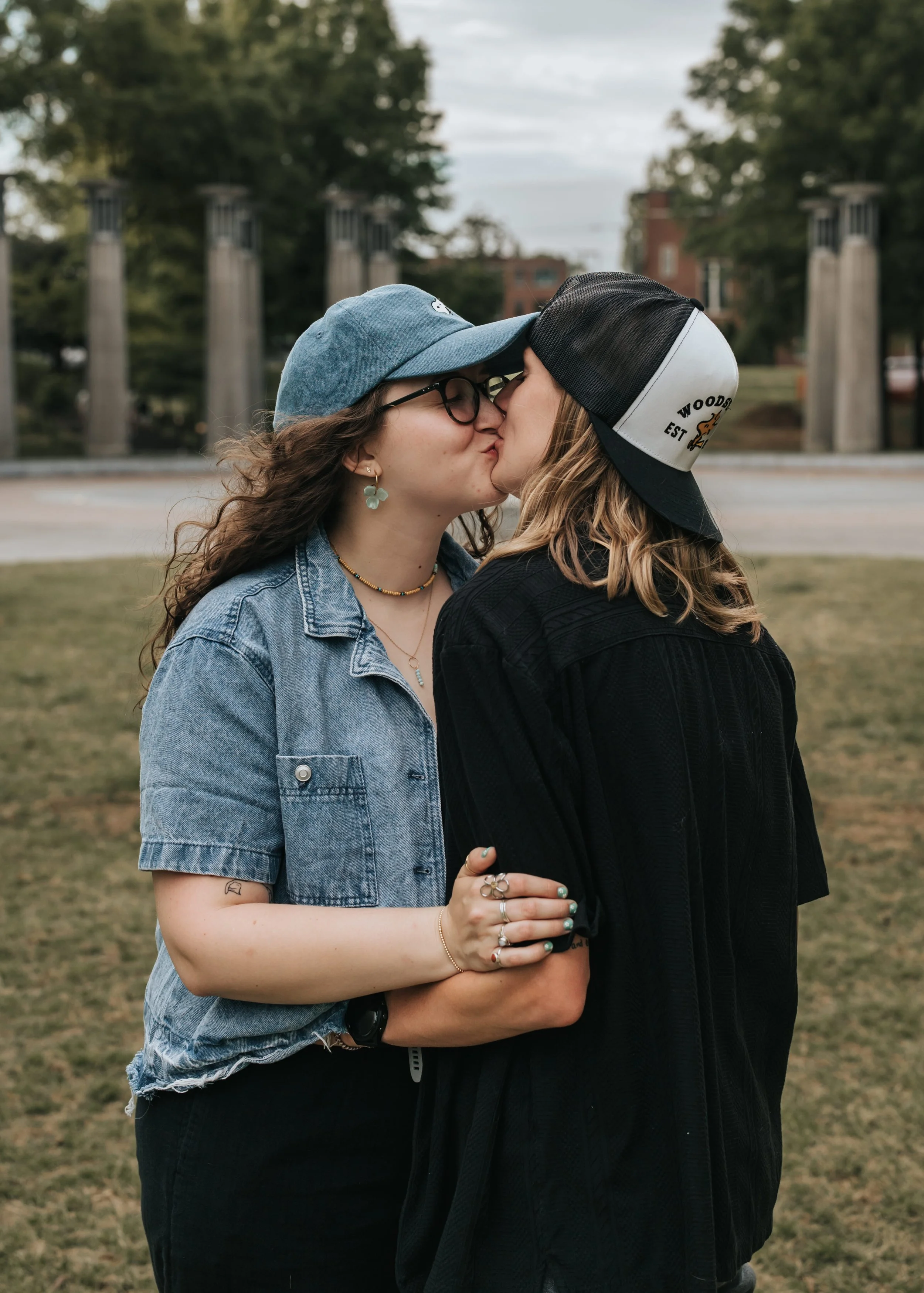  Maddie and Sarah, an LGBTQ+ couple in Nashville, kissing during their engagement photoshoot. 