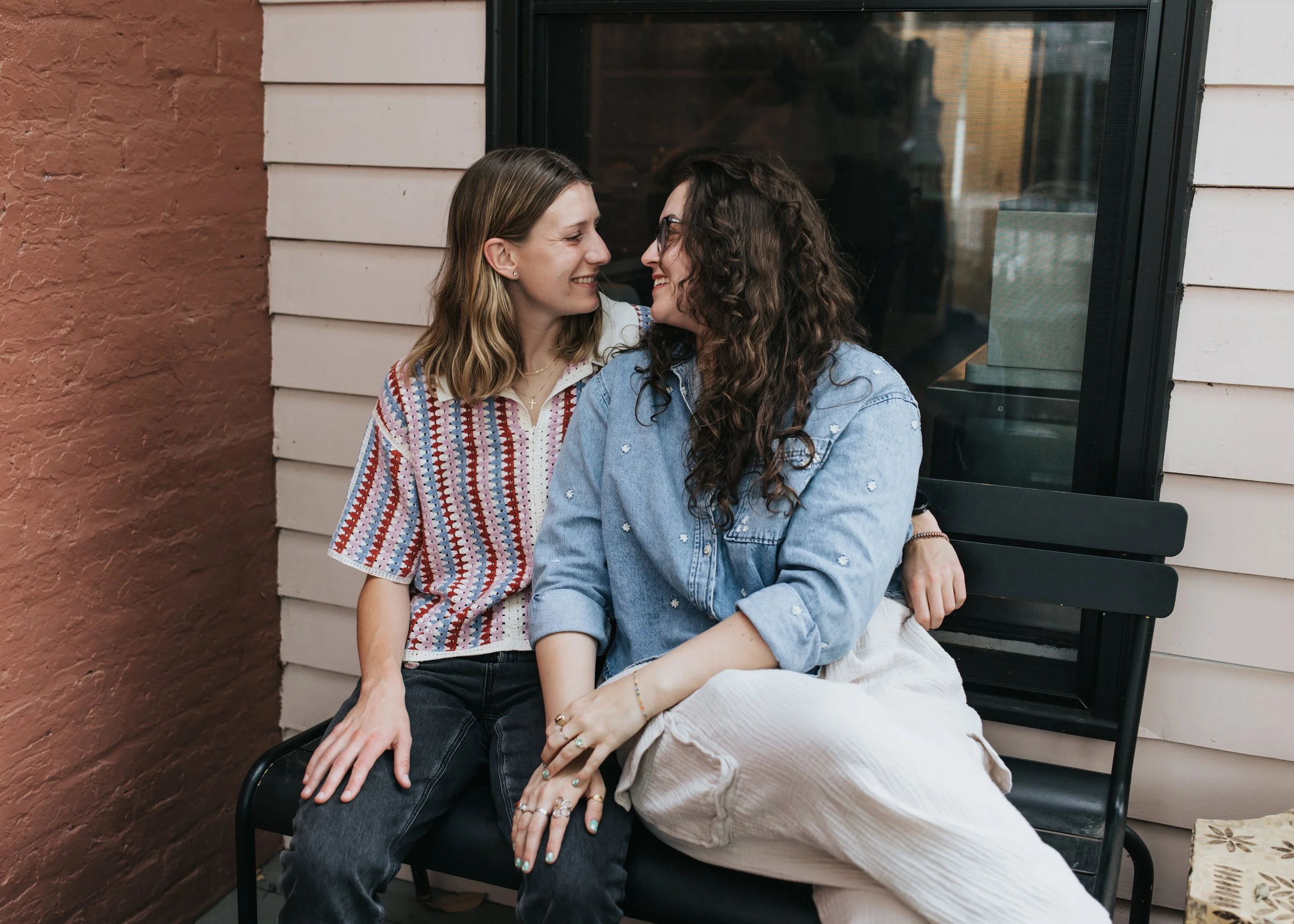  Maddie and Sarah photographed while sitting at a coffee shop during their LGBTQ+ engagement photoshoot in Nashville. 