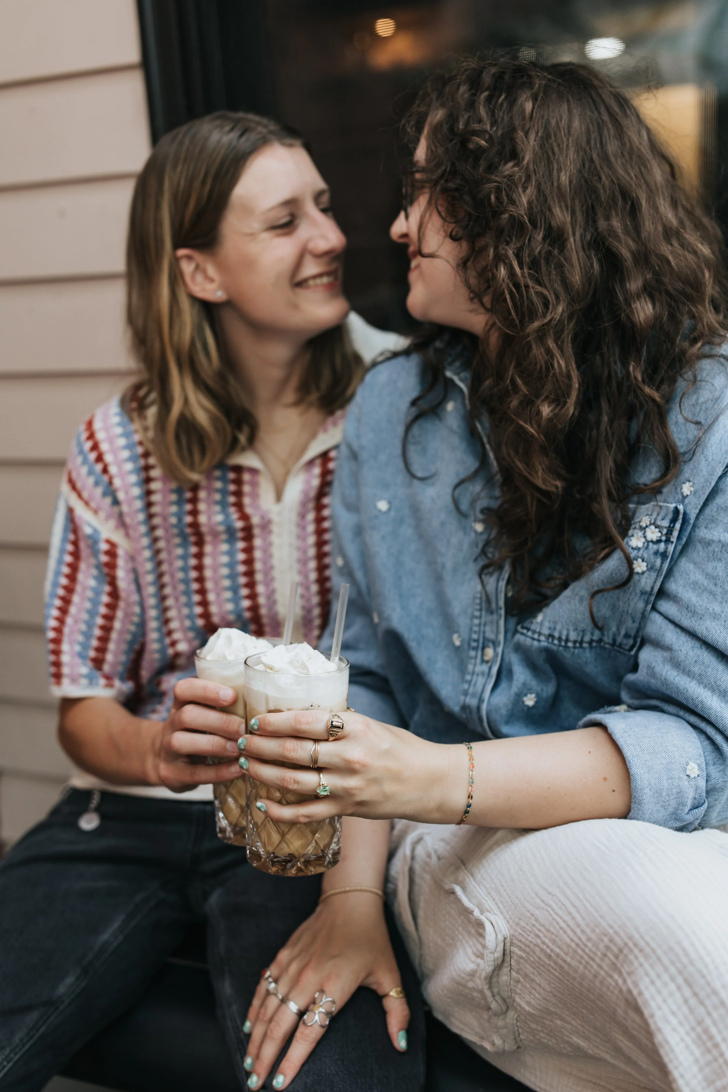  Maddie and Sarah photographed while sipping coffee during their LGBTQ+ engagement photoshoot in Nashville. 