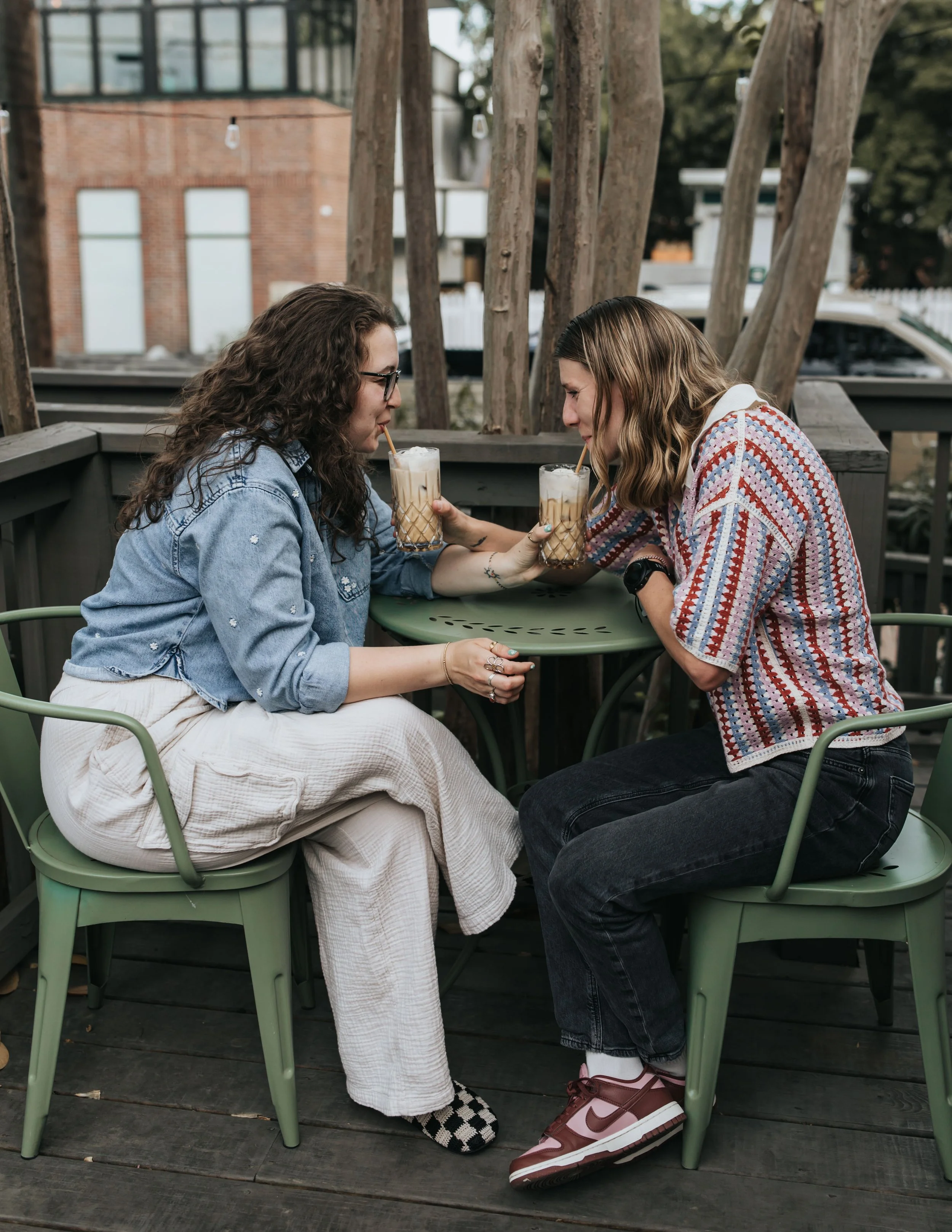  Maddie and Sarah photographed while sipping coffee during their WLW engagement photoshoot in Nashville. 