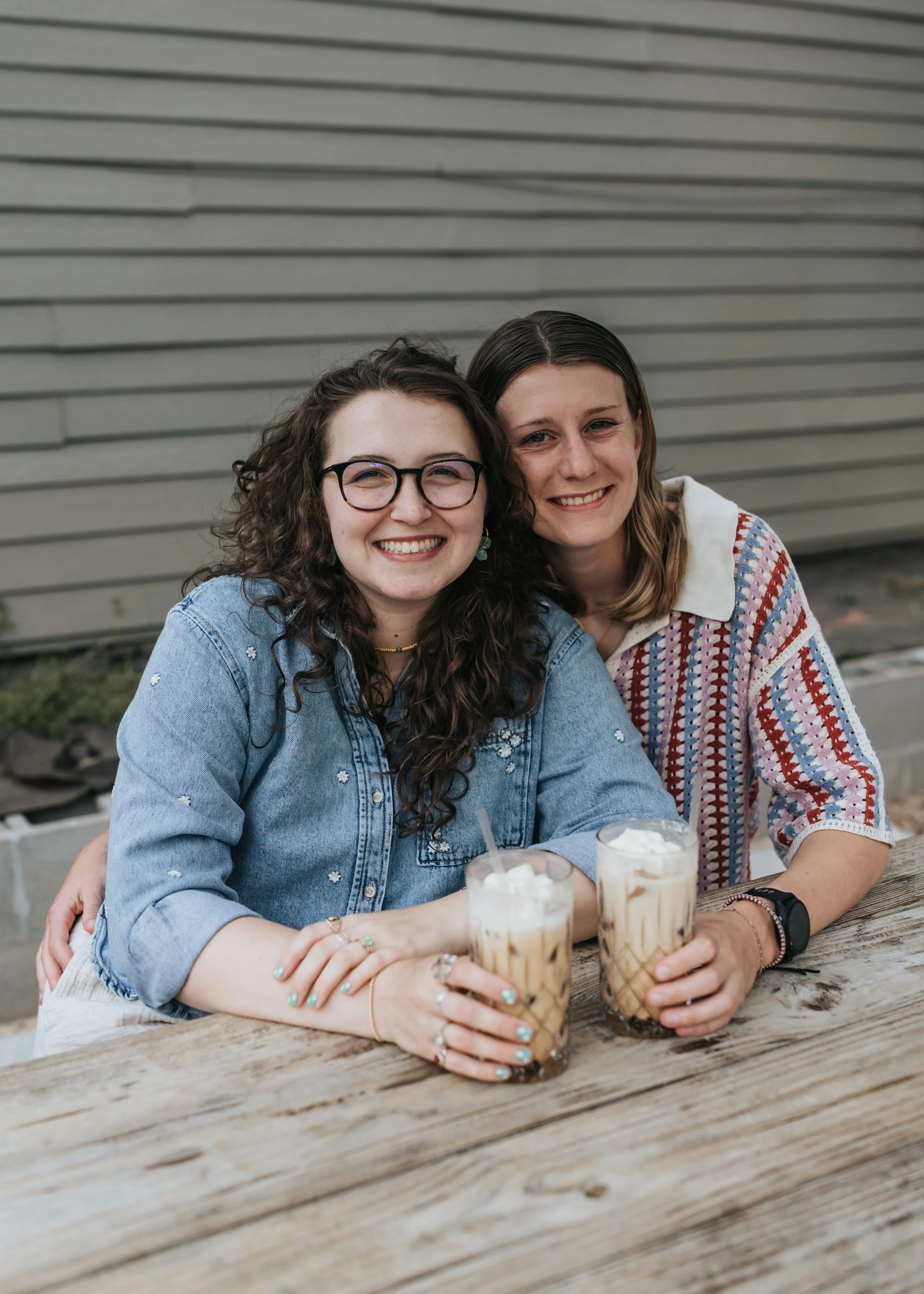  Maddie and Sarah photographed at a coffee shop during their WLW engagement photoshoot in Nashville. 