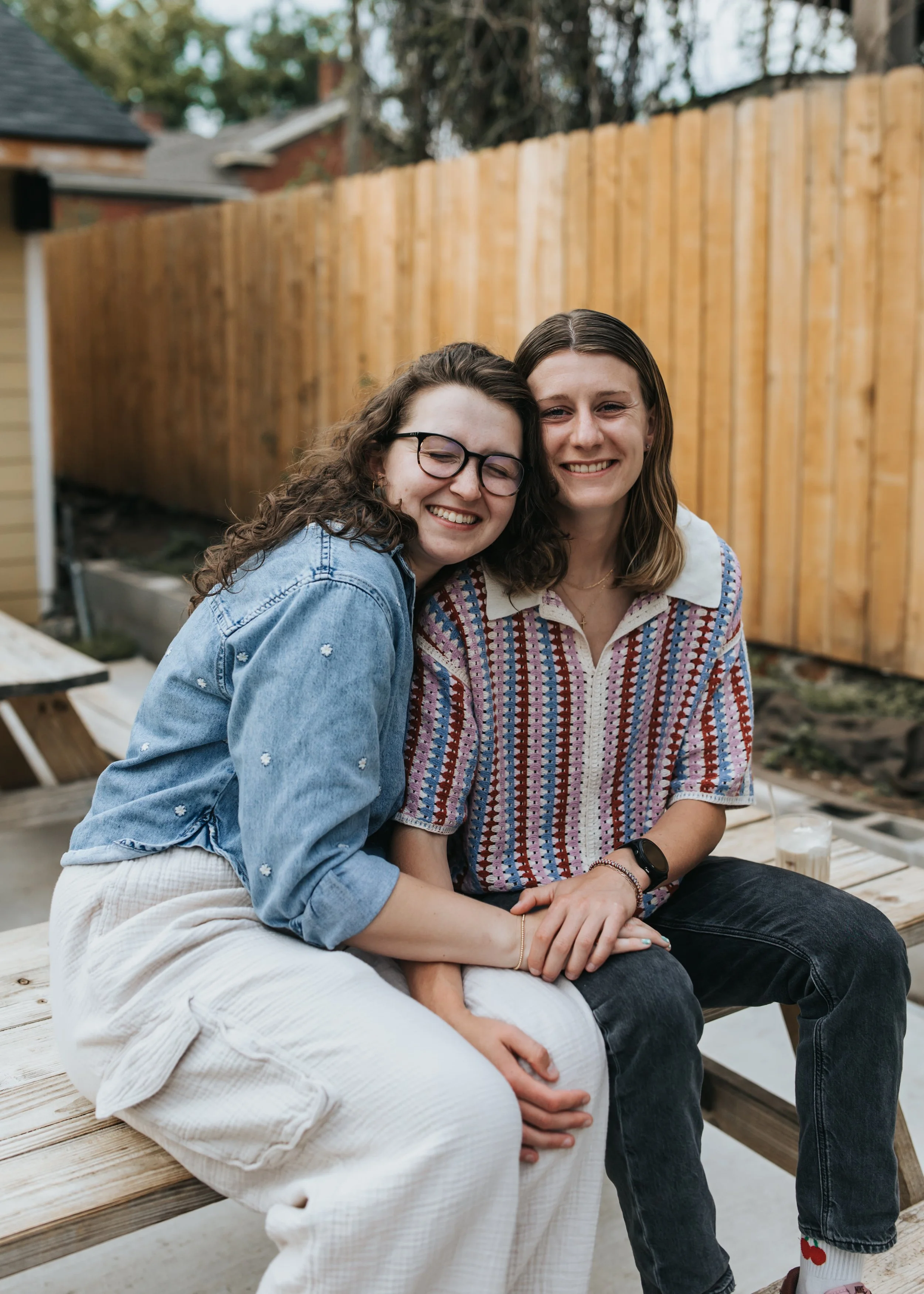  Maddie and Sarah photographed outside a coffee shop during their LGBTQ+ engagement photoshoot in Nashville. 