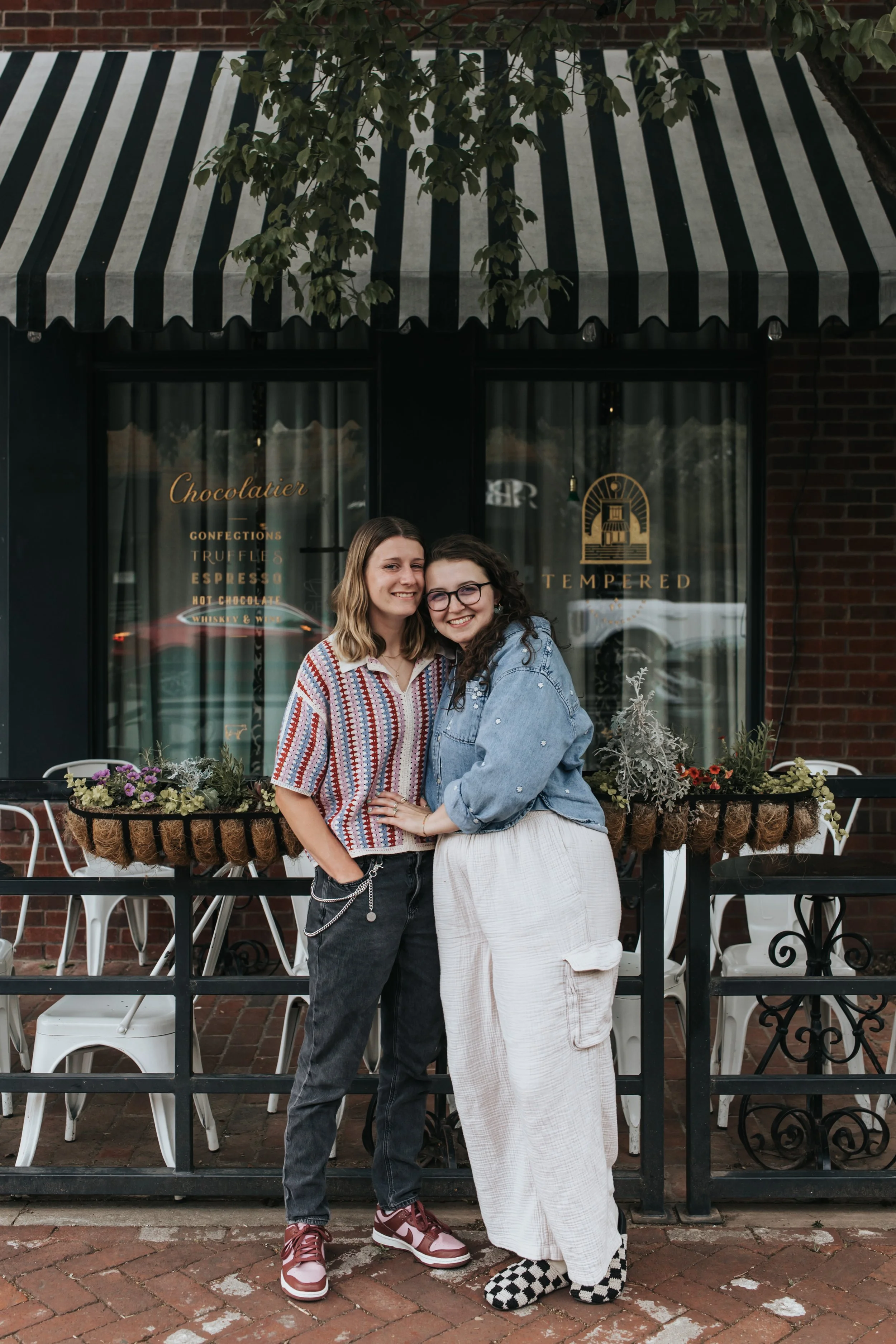  Maddie and Sarah photographed on the street in Germantown during their LGBTQ+ engagement photoshoot in Nashville. 