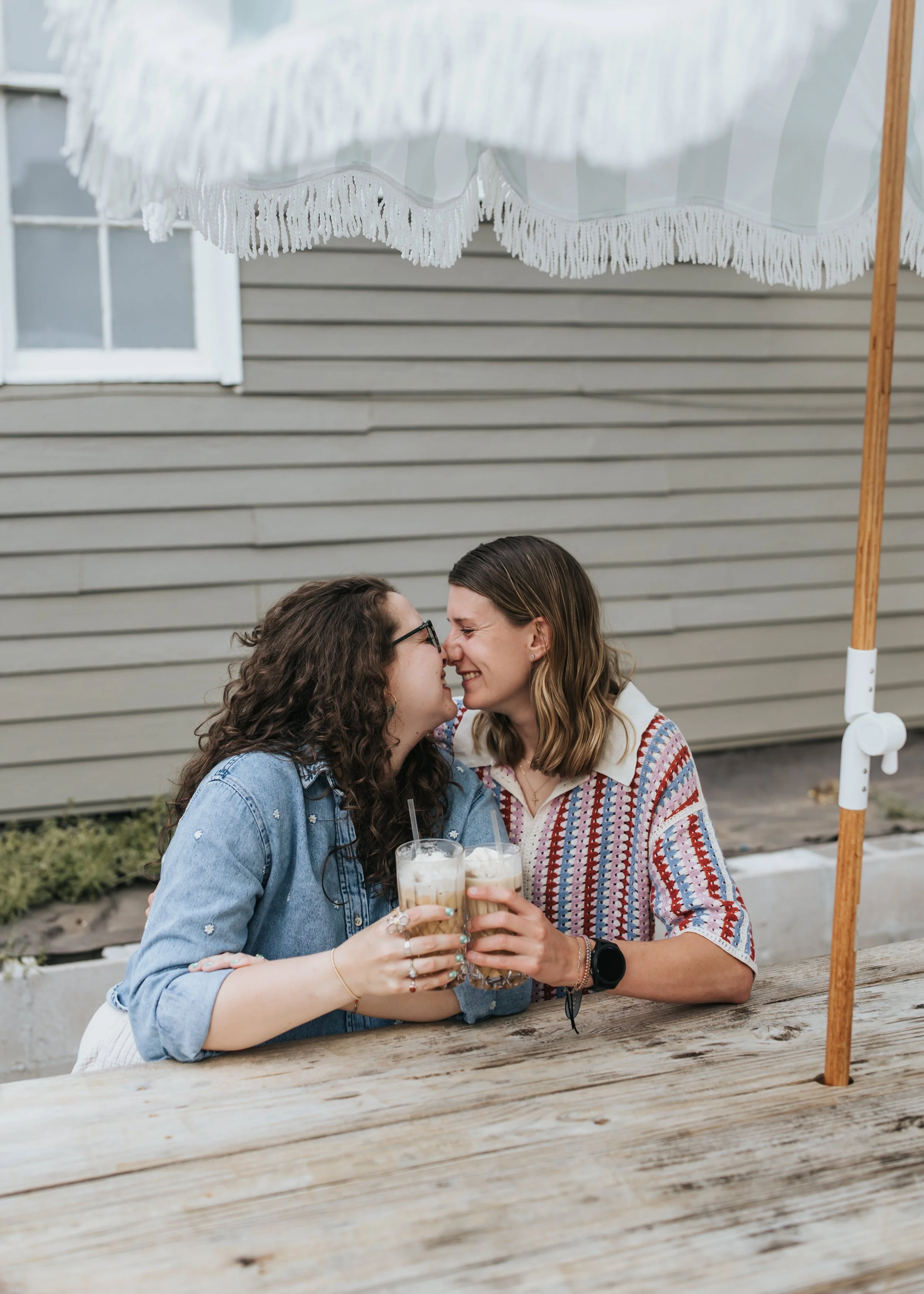  Maddie and Sarah photographed at a coffee shop during their engagement photoshoot. 