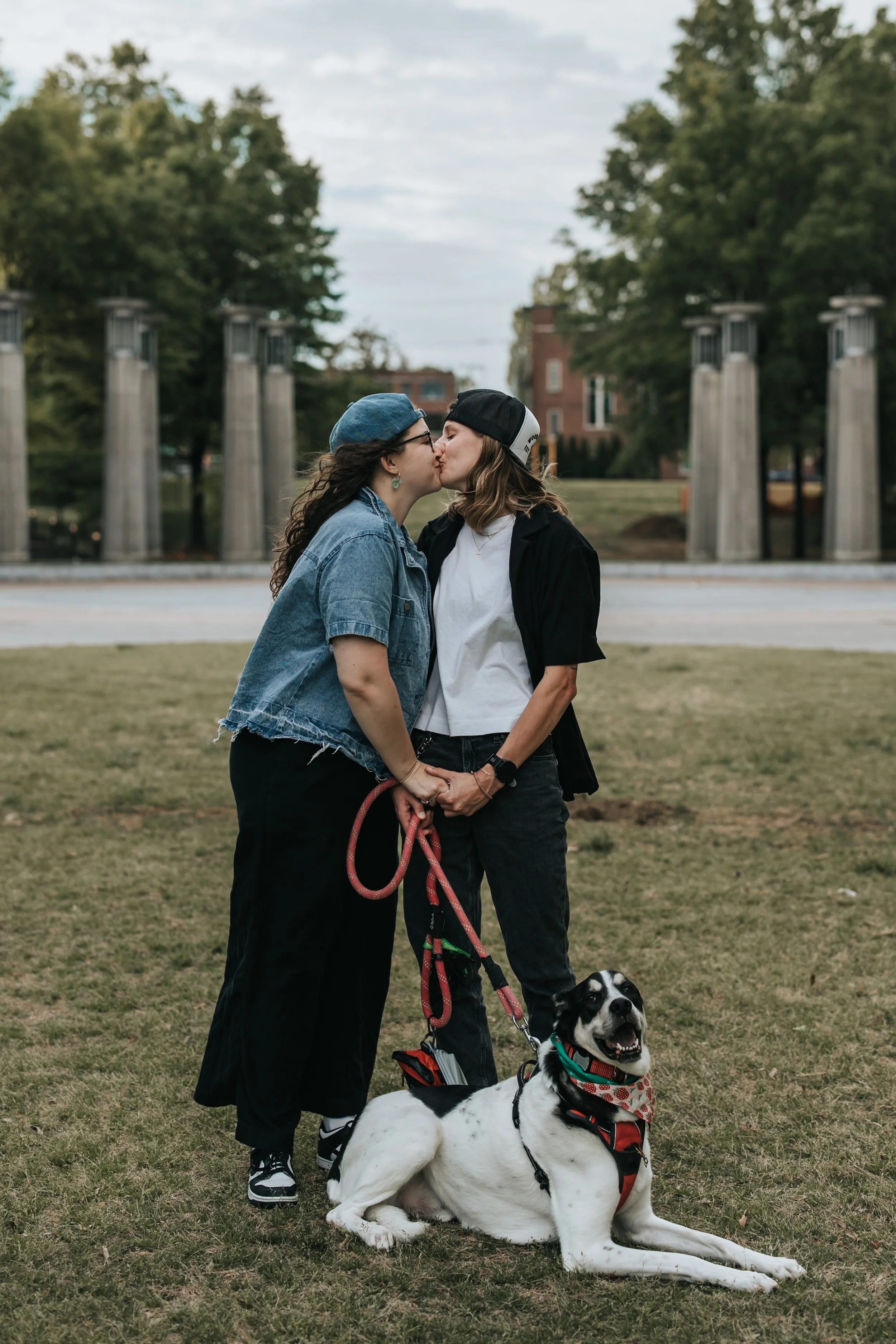  Maddie, Sarah, and their dog Bear at Bicentennial Park during their LGBTQ+ engagement photoshoot. 