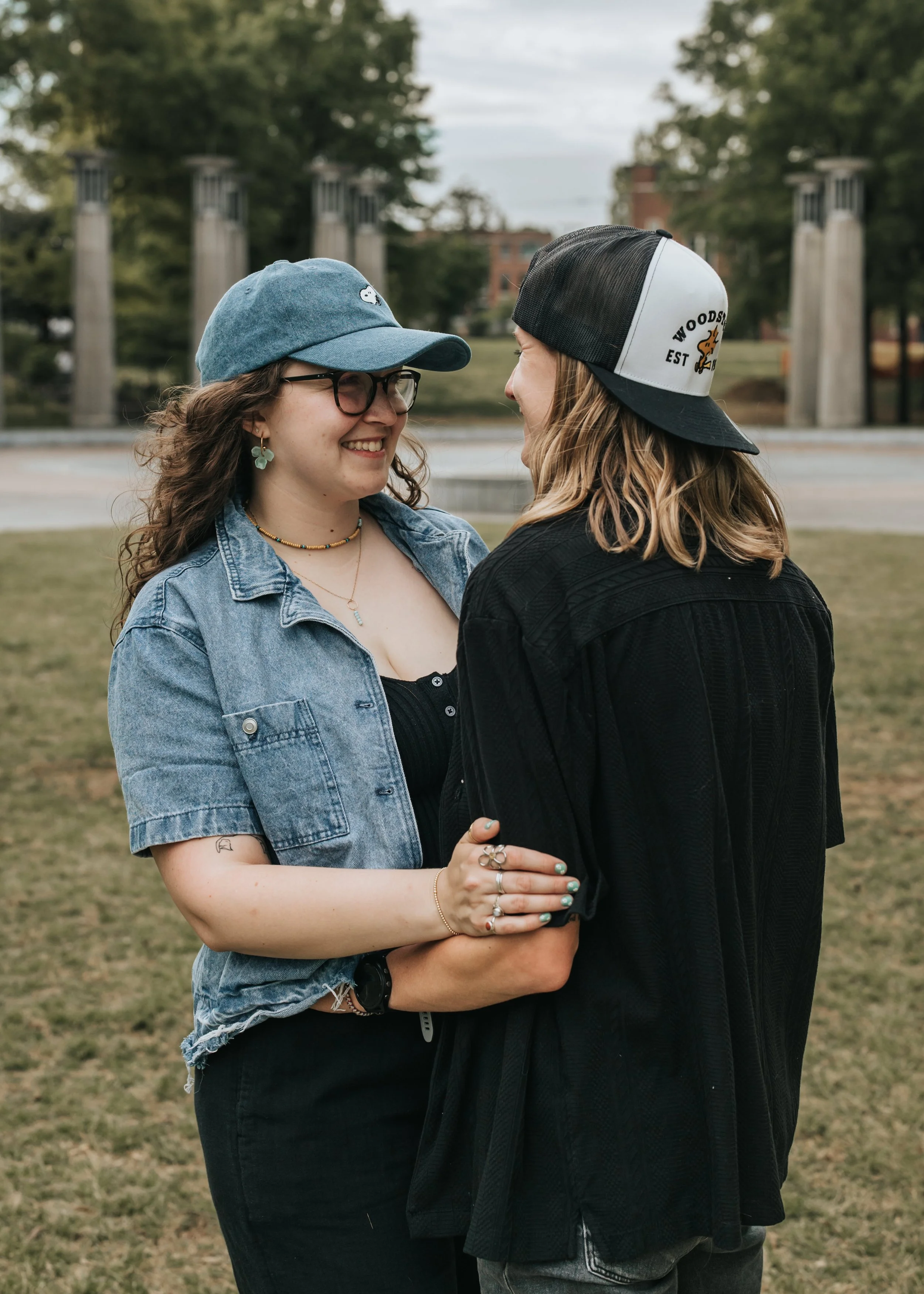  LGBTQ+ couple Maddie and Sarah show off their Snoopy and Woodstock hats during their engagement photoshoot at Bicentennial Park in Nashville. 