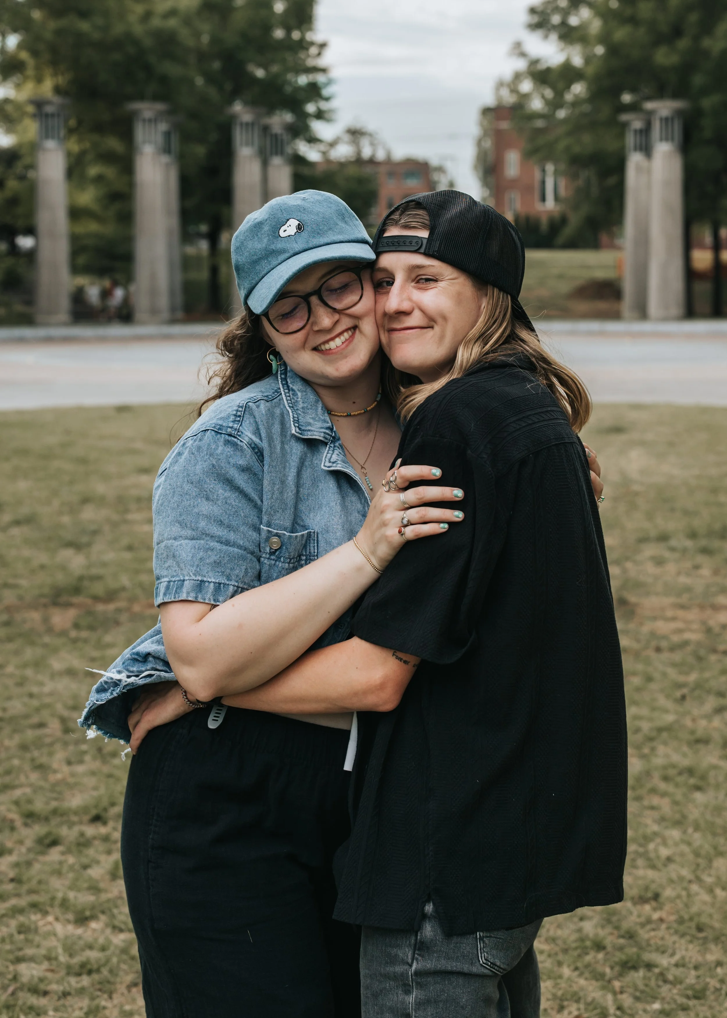  LGBTQ+ couple Maddie and Sarah show off their Snoopy and Woodstock hats during their engagement photoshoot at Bicentennial Park. 