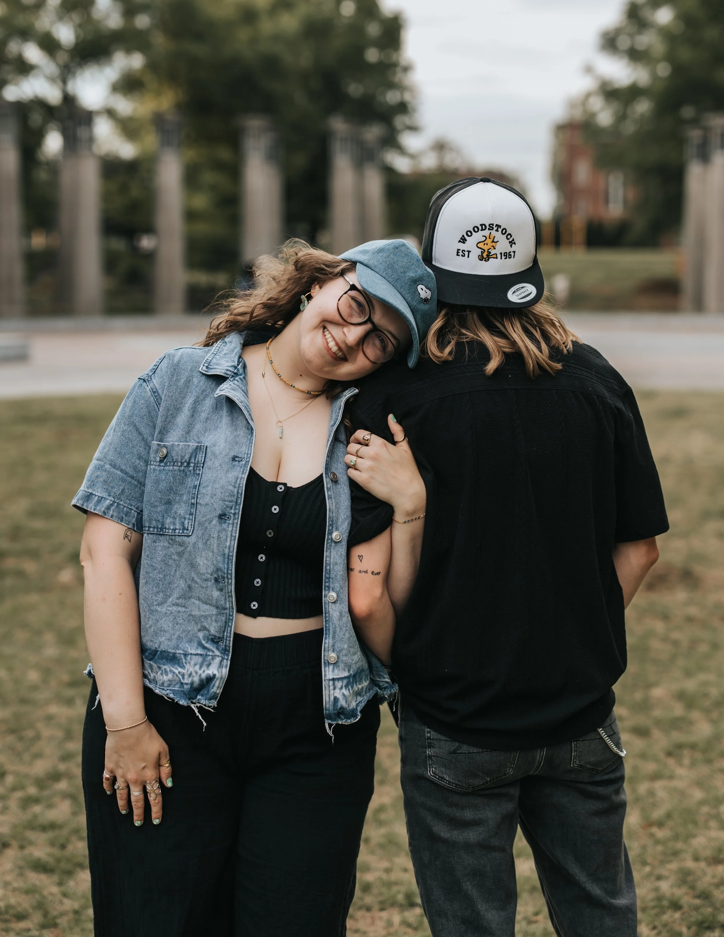  LGBTQ+ couple Maddie and Sarah show off their Snoopy and Woodstock hats during their engagement photoshoot at Bicentennial Park in Nashville. 
