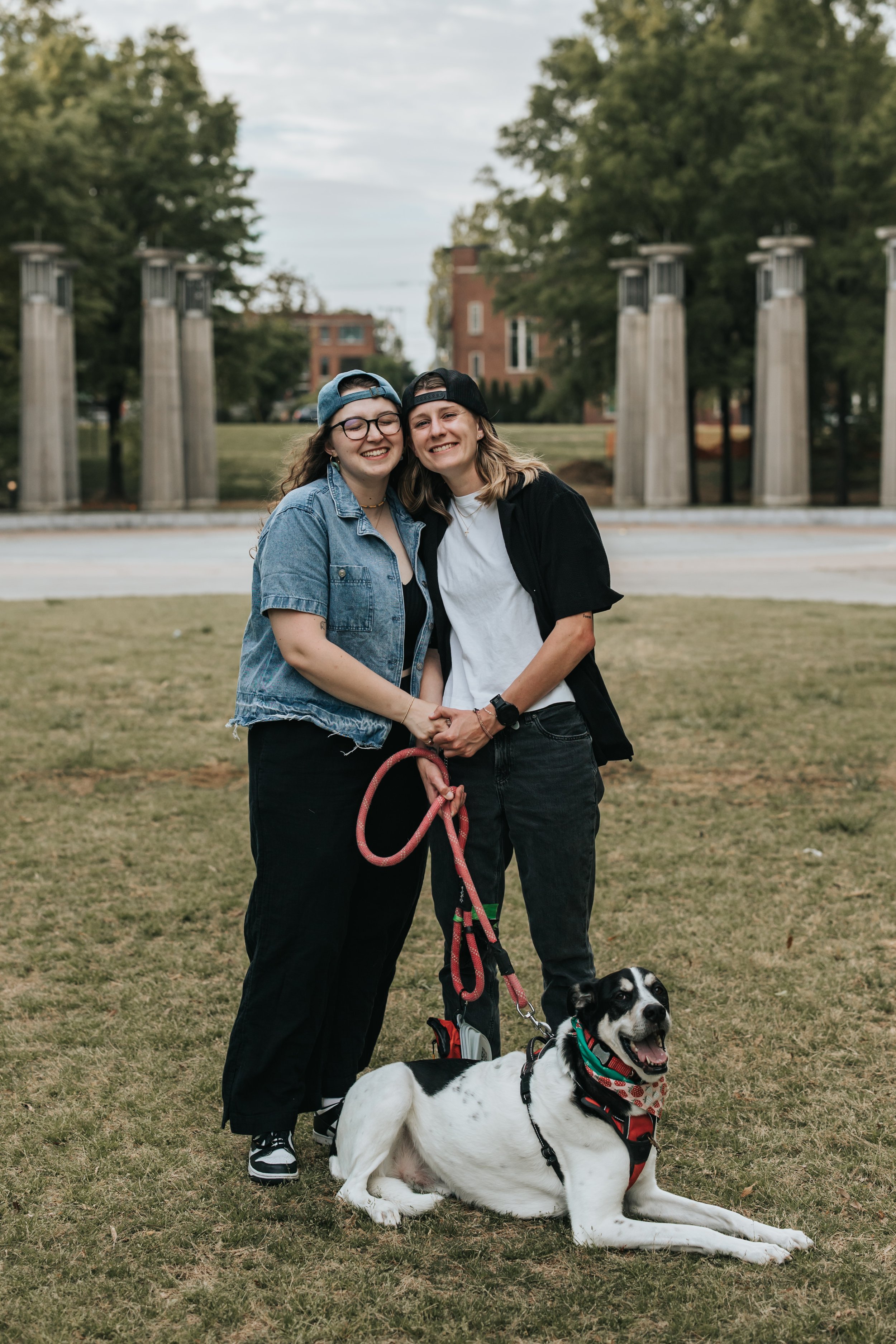 Maddie, Sarah, and their dog Bear at Bicentennial Park during their engagement photoshoot.