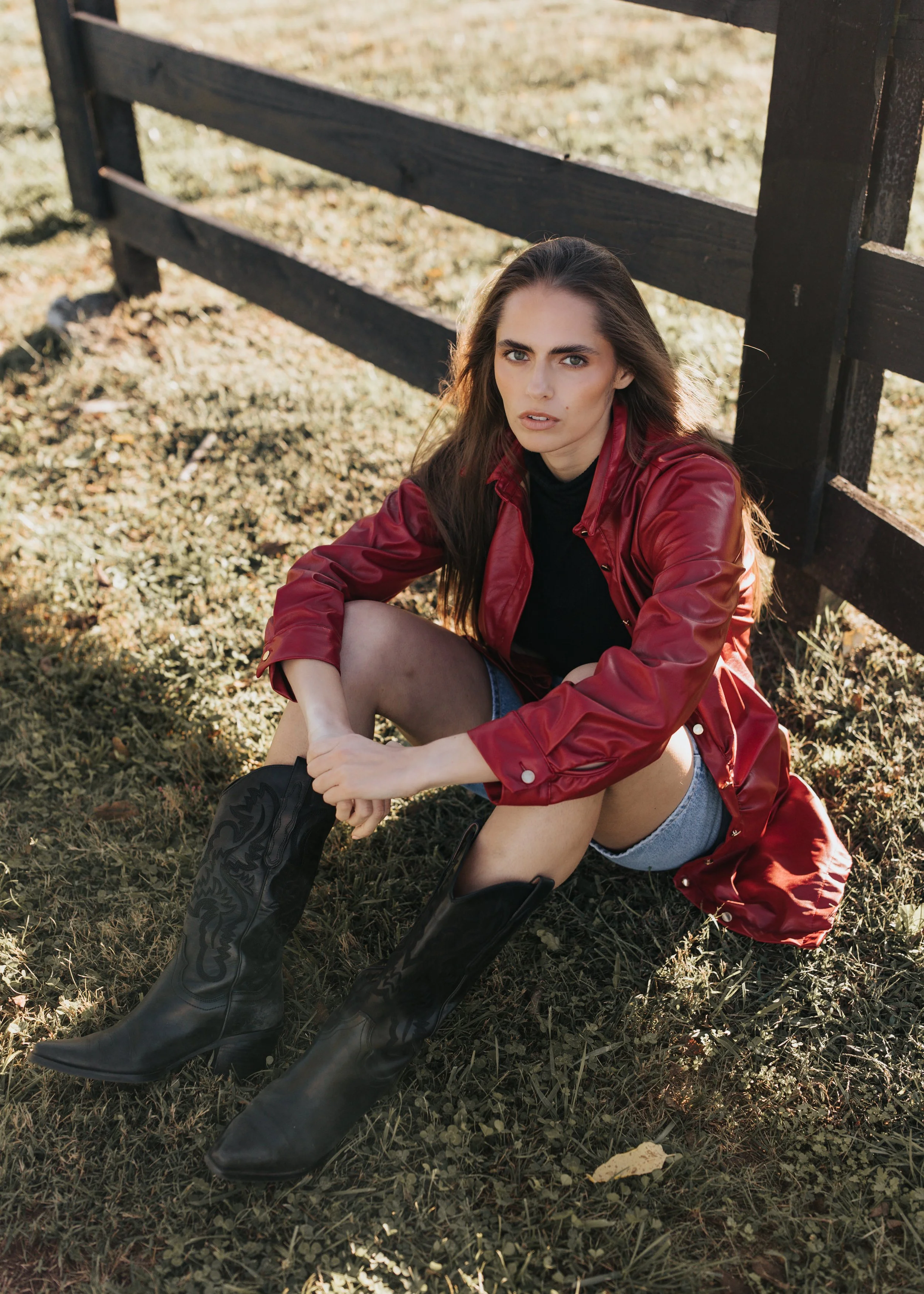  Model Skylar poses wearing a red jacket and denim shorts during her Nashville fashion photoshoot. 