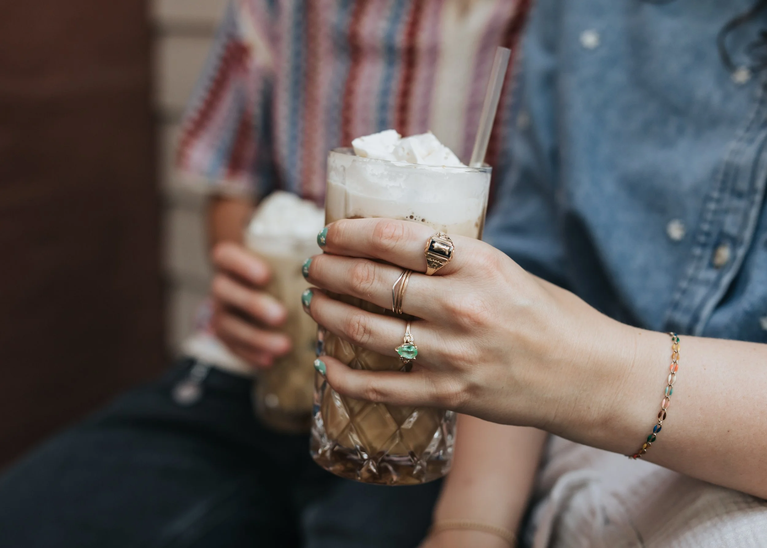 Sarah's hand around her coffee cup during her engagement photoshoot.