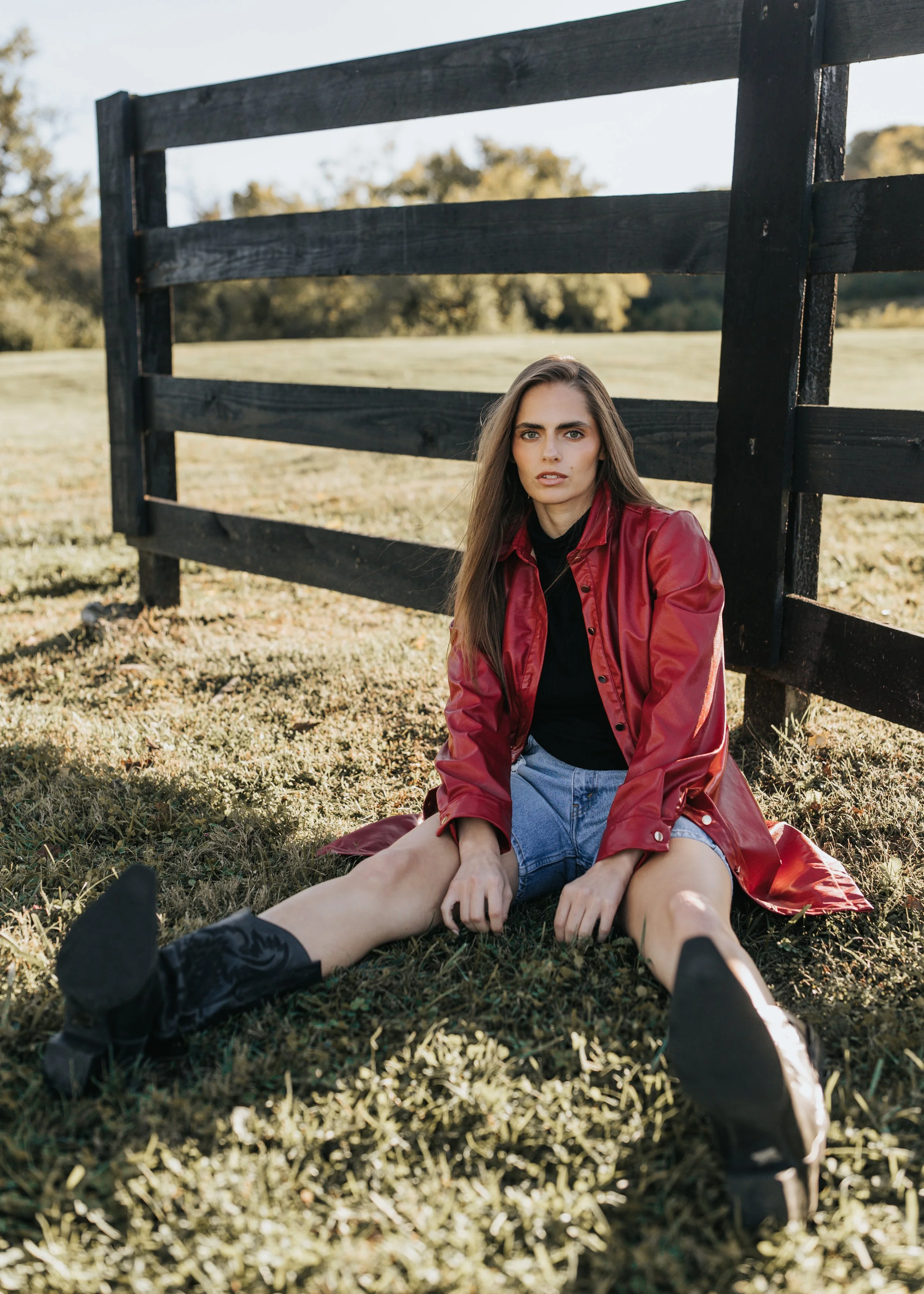  Model Skylar poses wearing a red jacket and denim shorts during her Nashville fashion photoshoot. 