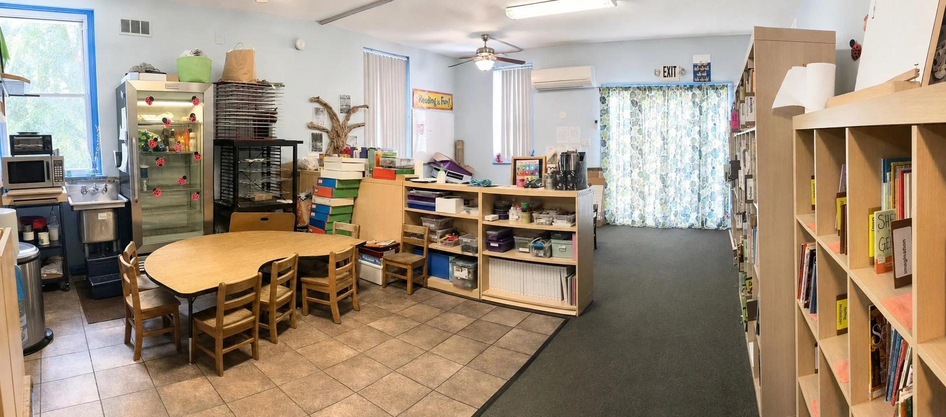 Preschool classroom with child-sized tables, art supplies, books, and reading areas at Beginnings Learning Center