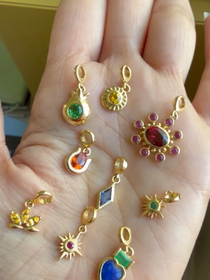 A curated selection of our most cherished symbols, ready to ship. From the celestial Sun and crescent Moon to protective pomegranates and luminous emerald leaves, each piece carries meaning meant to be worn and passed down.

If you see something here