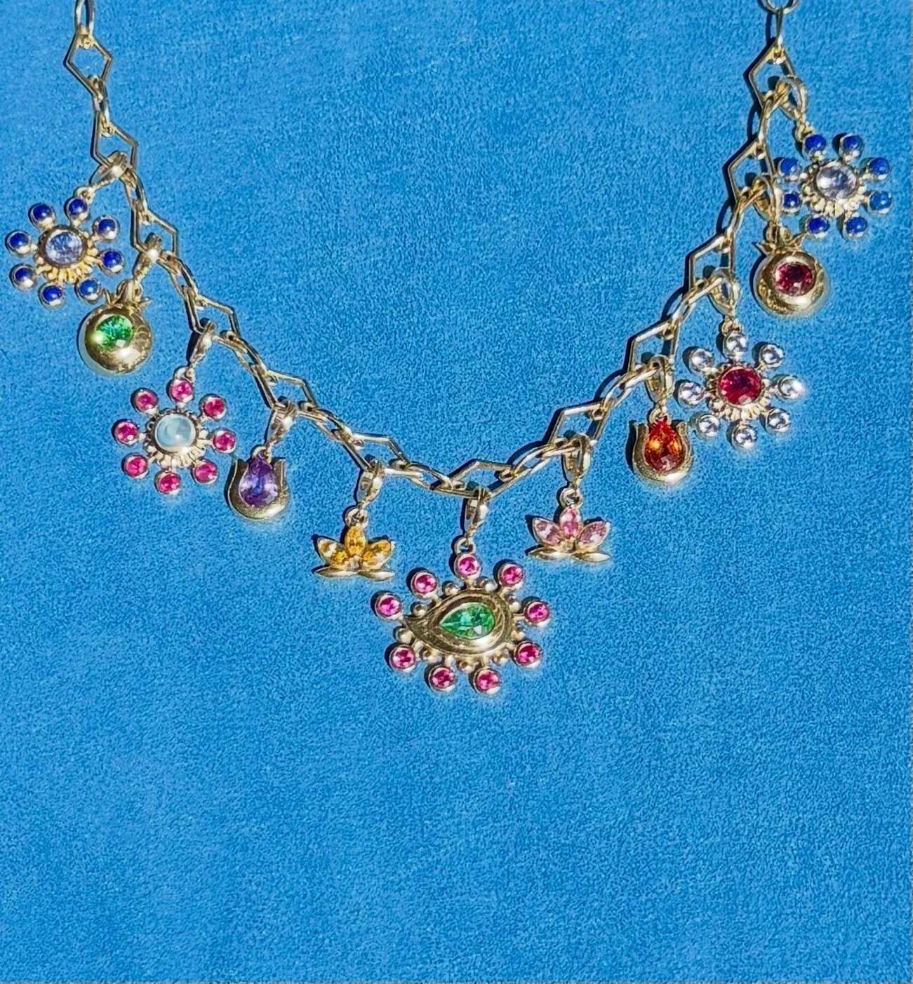 Wear your own dazzling garden close to your heart. 🌸🌷🪷🪻Our Zan Foundational Chain holding our Botah, Lotus, Tulip, Pomegranate, and Flower Cosmos charms, each one a living symbol representing a different aspect of you. 

The Pomegranate for abund