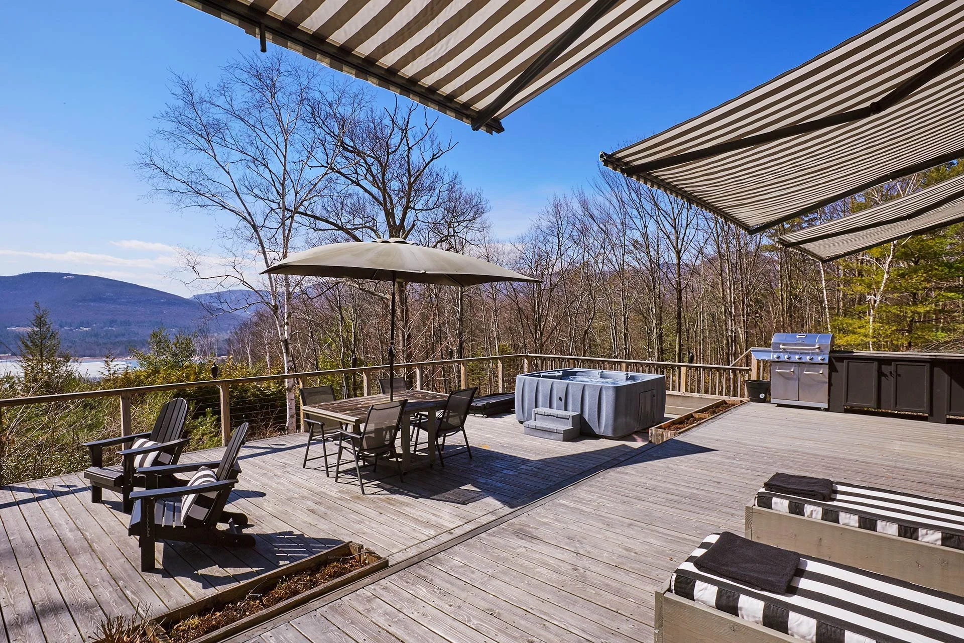 stylish-mountain-house-with-reservoir-views--deck-striped-loungers.jpg