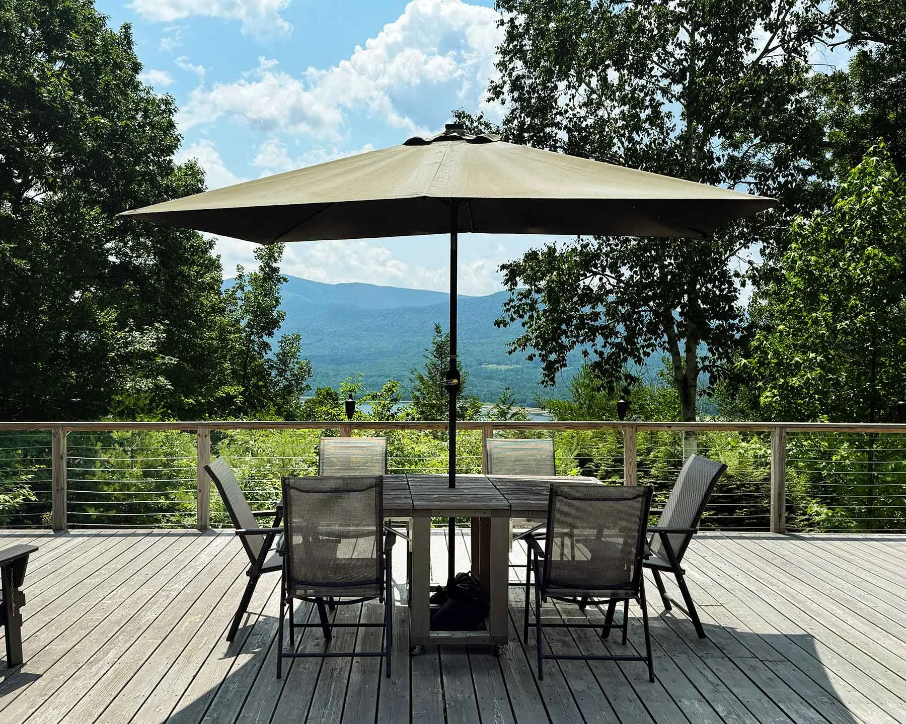 Stylish-mountain-house-reservoir-views-deck-dining.jpg
