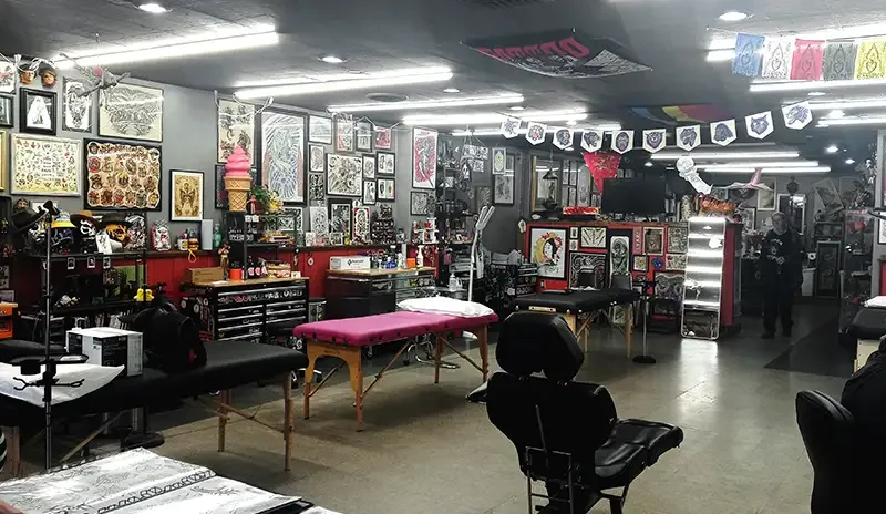 Interior shot of Tiger Tattoo Shop with art and flash.