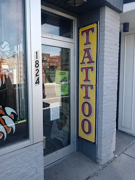 Front door of Tiger Tattoo Shop with a sign that says Tattoo