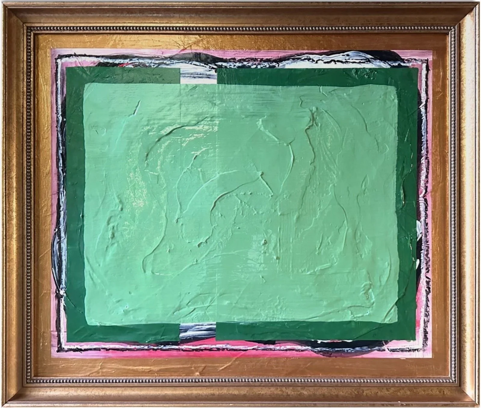 Abstract painting with layers of textured green and pink colors in a gold frame.