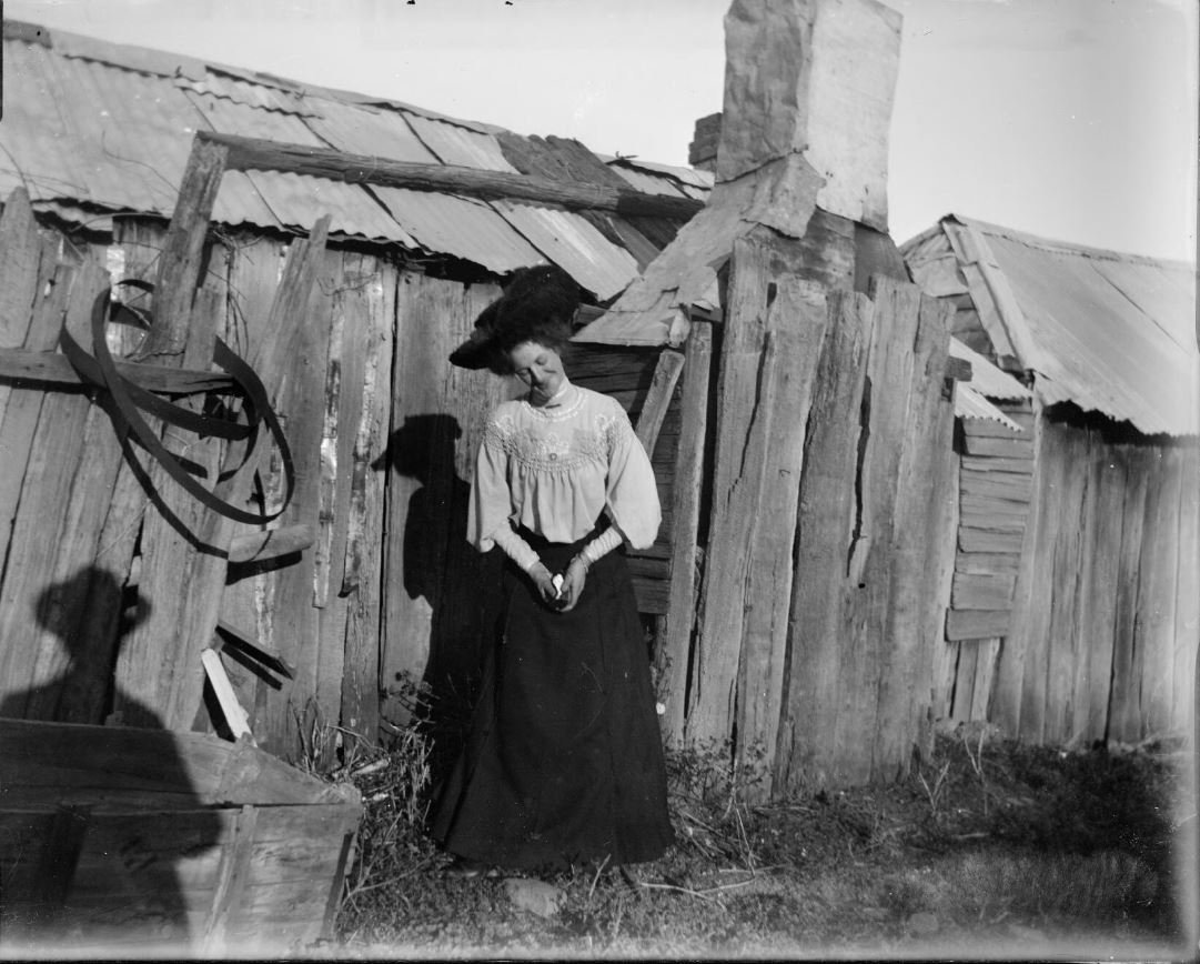 Ida Pearce standing by a bark hut at Reno goldfields, Gundagai, New South Wales [picture] / Charles Gabriel