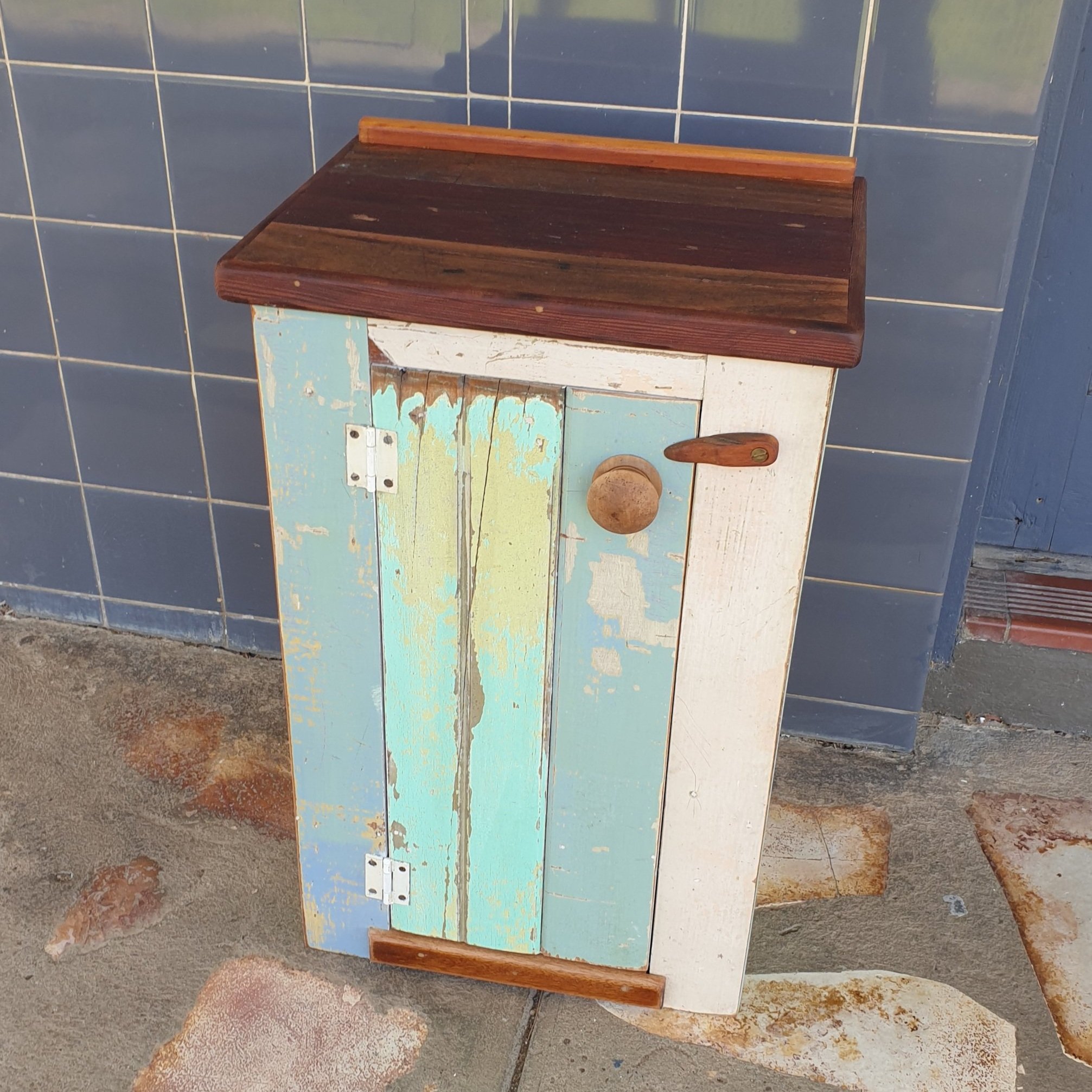 #958 'Bobbie' one-door cupboard with internal shelf; hardwood top (recycled floorboards from Kandos Museum), painted lining board sides from 2 cottages in Newcastle, finished with kaurie and western red cedar; 400 w x 320 d x 670 h; $420
