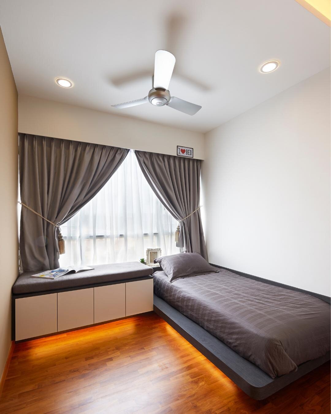 Rich wood tones envelop this bedroom to form a warm, encompassing area to rest in. The cheeky 'I love Bed' sign is just further proof of how much this homeowner loves the bedroom!