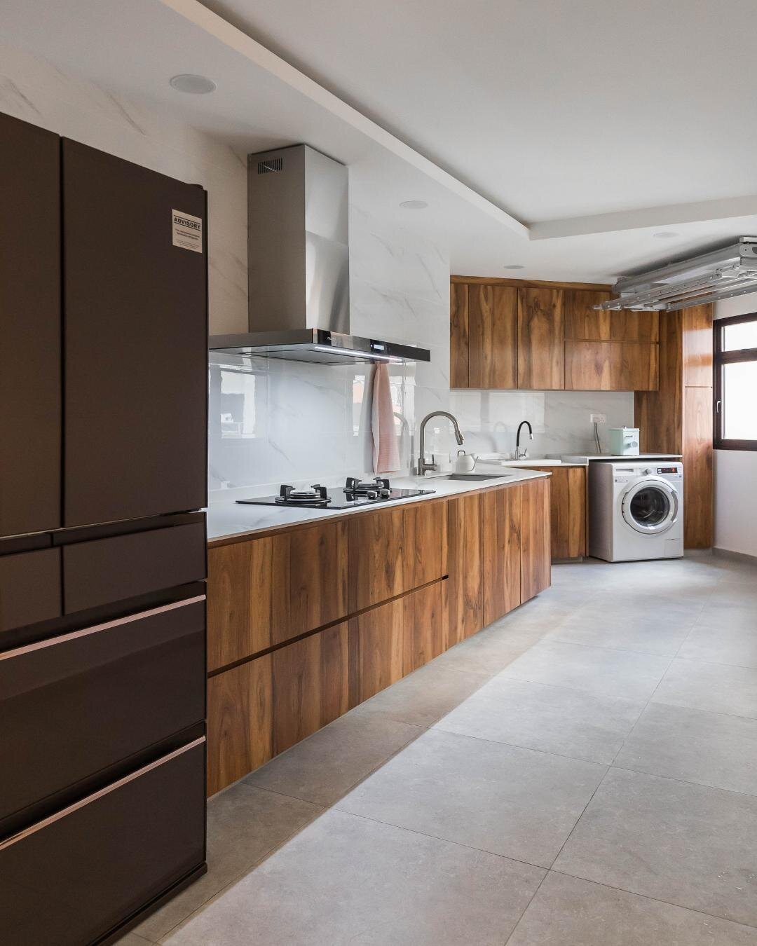 Use wooden tones to set a tranquil atmosphere in your kitchen. Grey accents and marble textures surround the crisp white foundation to give a bright and airy space. The palette combination pairs really nicely with the natural lighting that this area 