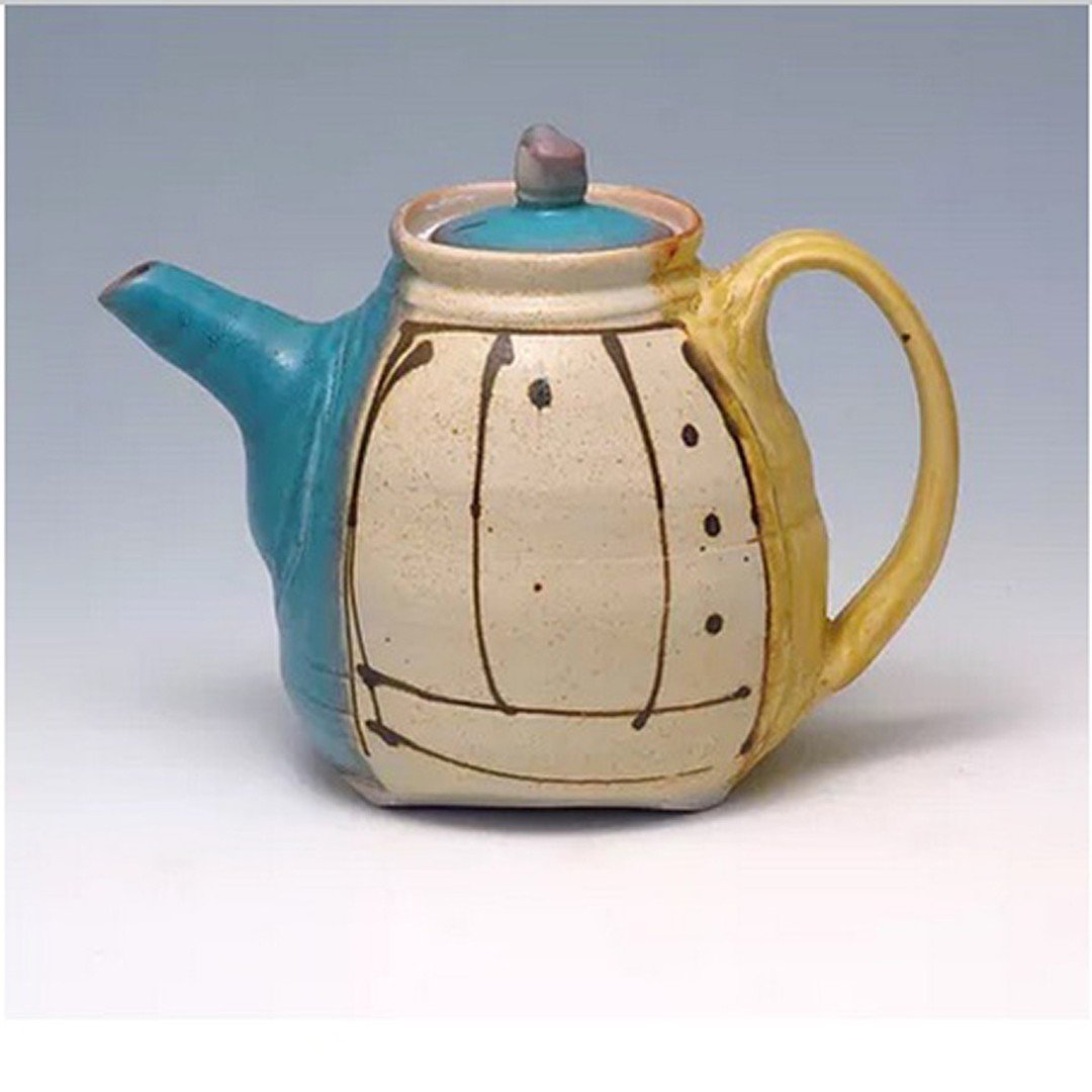 A lovely teapot that holds both tradition and warmth. Handcrafted by Delores Fortuna. See her new work this summer at SideStreet Gallery! https://www.hughesbosca.com/side-street-gallery

#tea #teapot #ceramicteapot #clay #vessel #yellowochre #turquoi