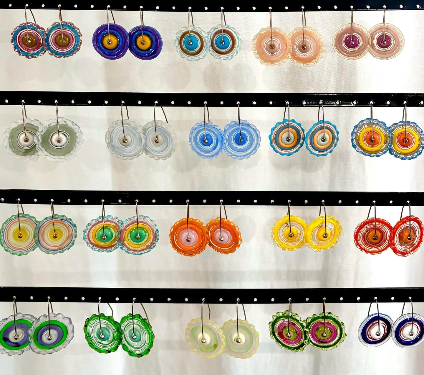 Such beautiful glass earrings, handblown in Gloucester, by Beth Williams! 🌀🍏✨ 

Her vibrant color combinations are sure to lift your mood on any dull winter day. Come try them on at the gallery! 

We&rsquo;re open 10-5 Tuesday through Saturday 💜

