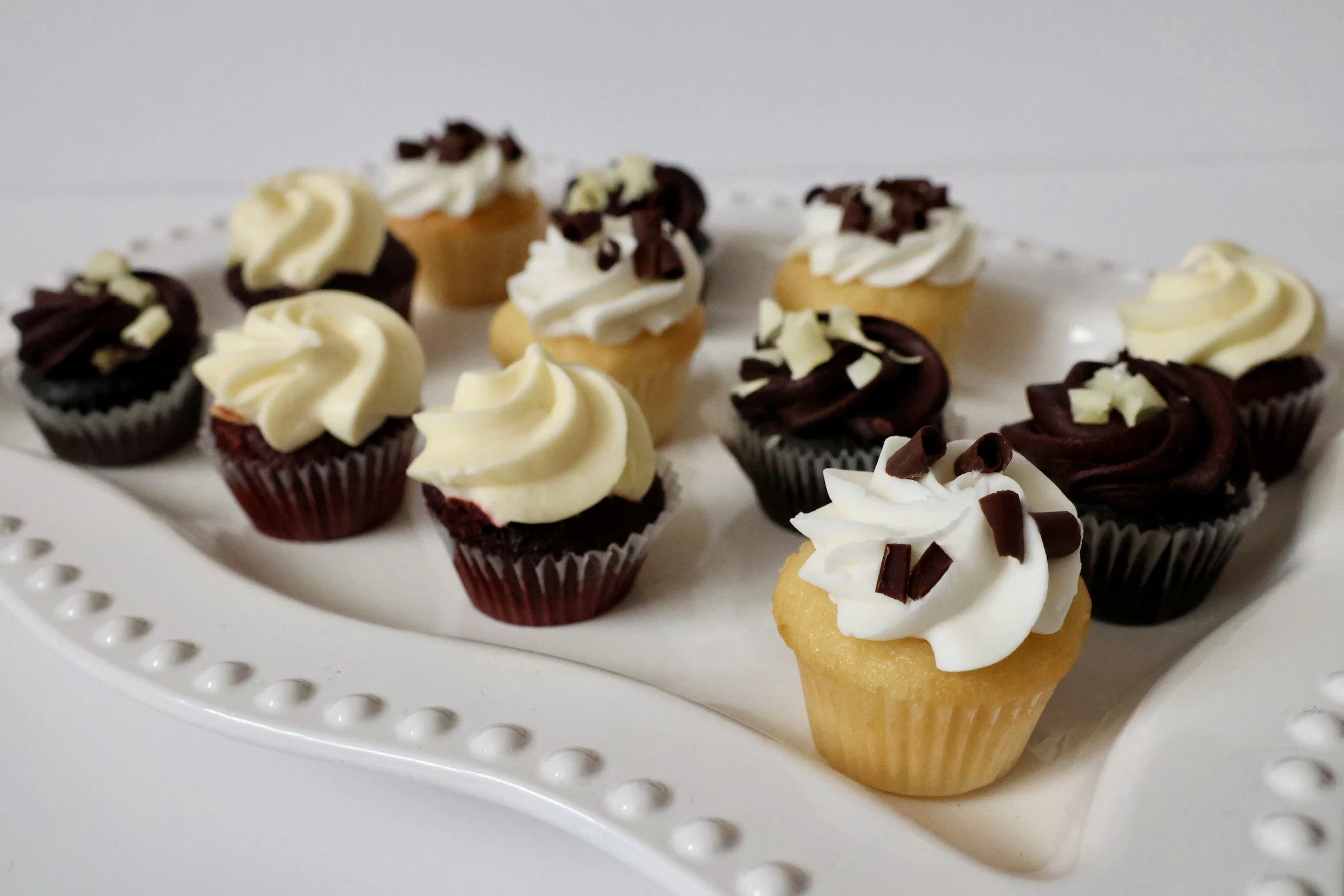  ASSORTED MINI CUPCAKES:  Bite sized versions of the classic cupcake. A perfect treat for any time and all occasions. These are sold as a 42 count case. Flavors include; chocolate, red velvet and vanilla.   Item #53161 (42ct case) 